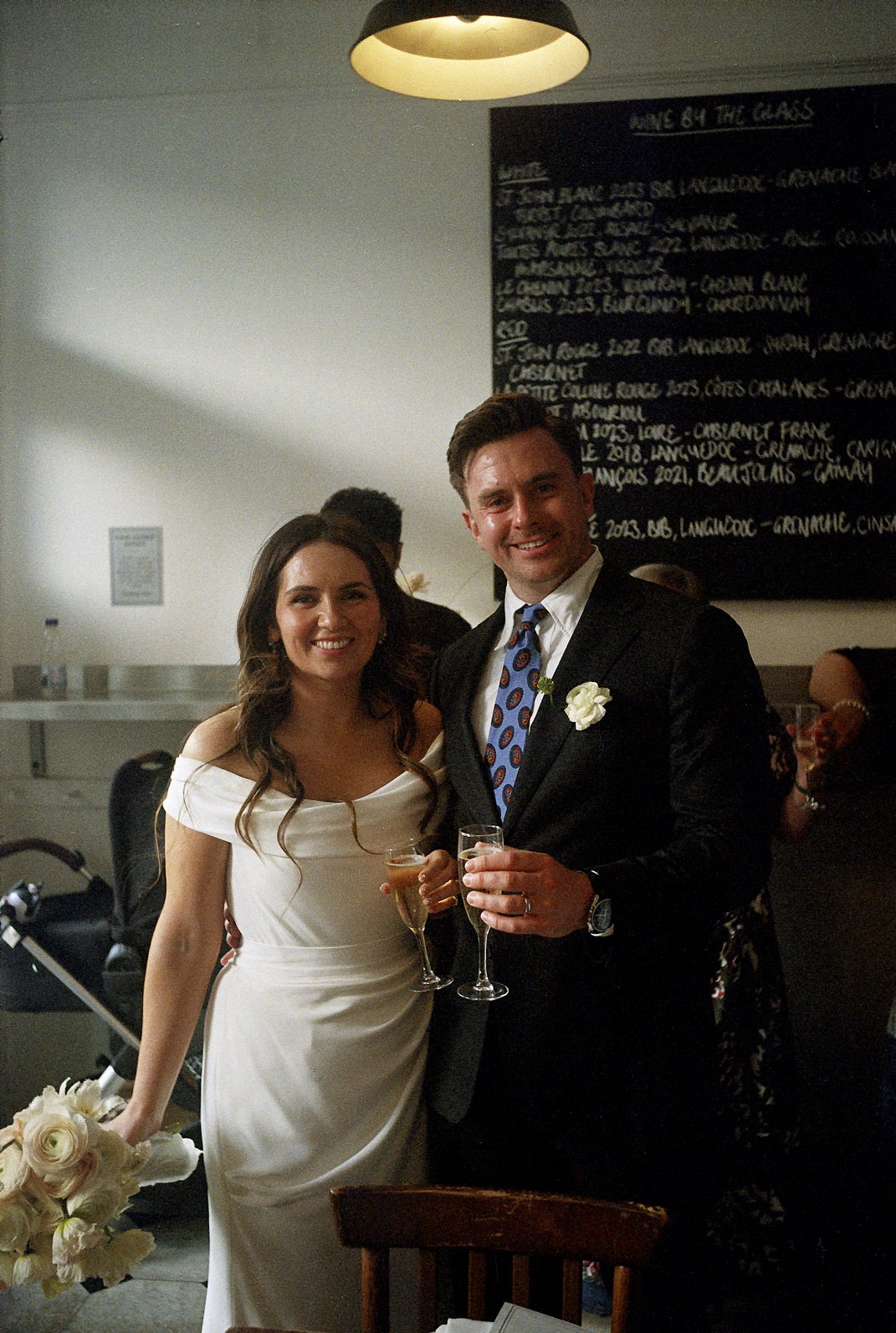 Wedding-couple-with-drinks-at-restaurant-old-school-film.jpg