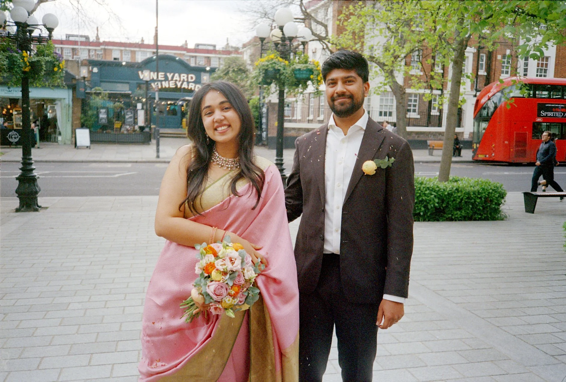 wedding-Couple-outside-town-hall-covered-in-confetti-with-flowers-looking-cute.jpg