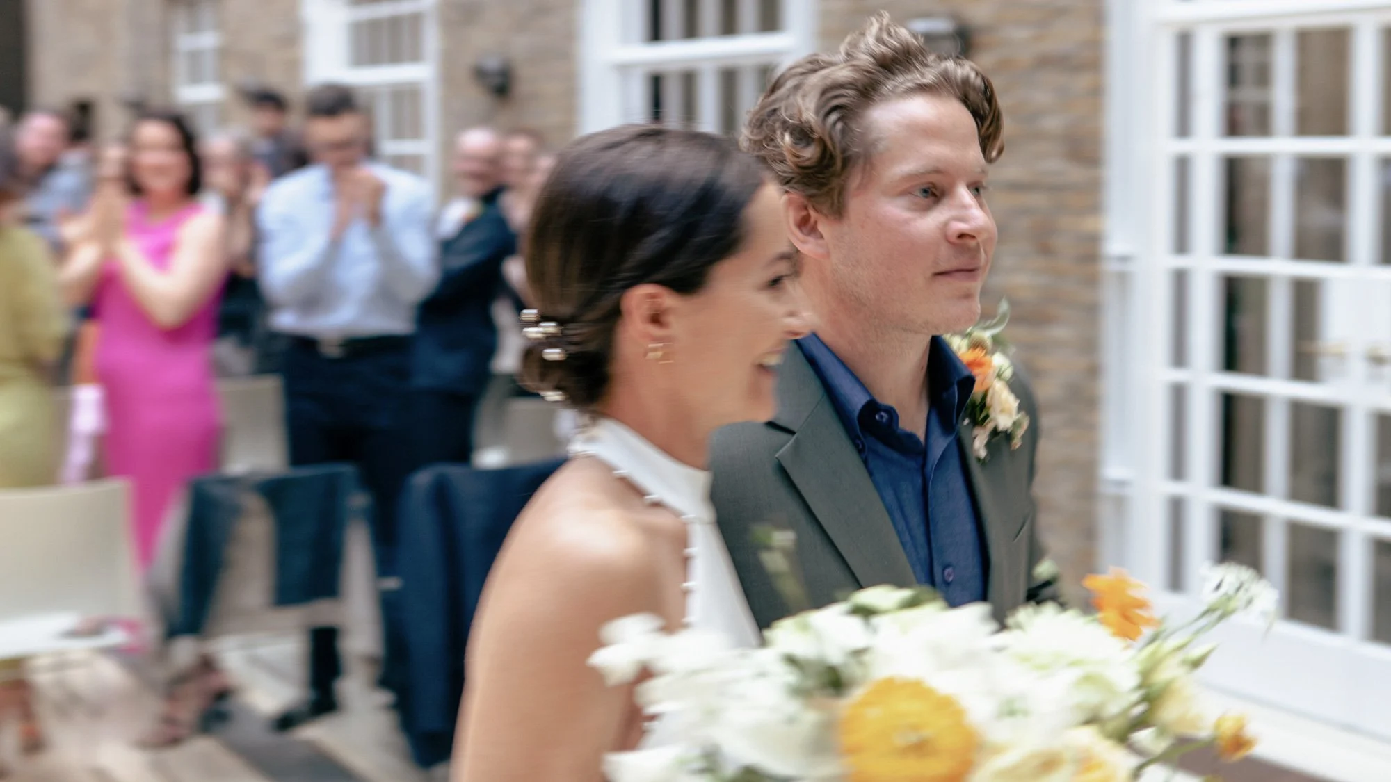 Blurred-photo-of-couple-leaving-ceremony-with-flowers.jpg