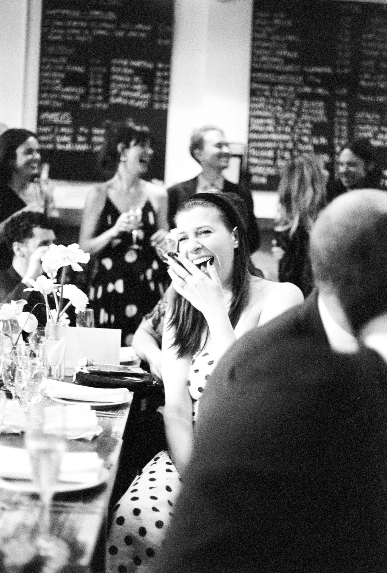 Wedding-Guest-laughing-at-restaurant-table.jpg