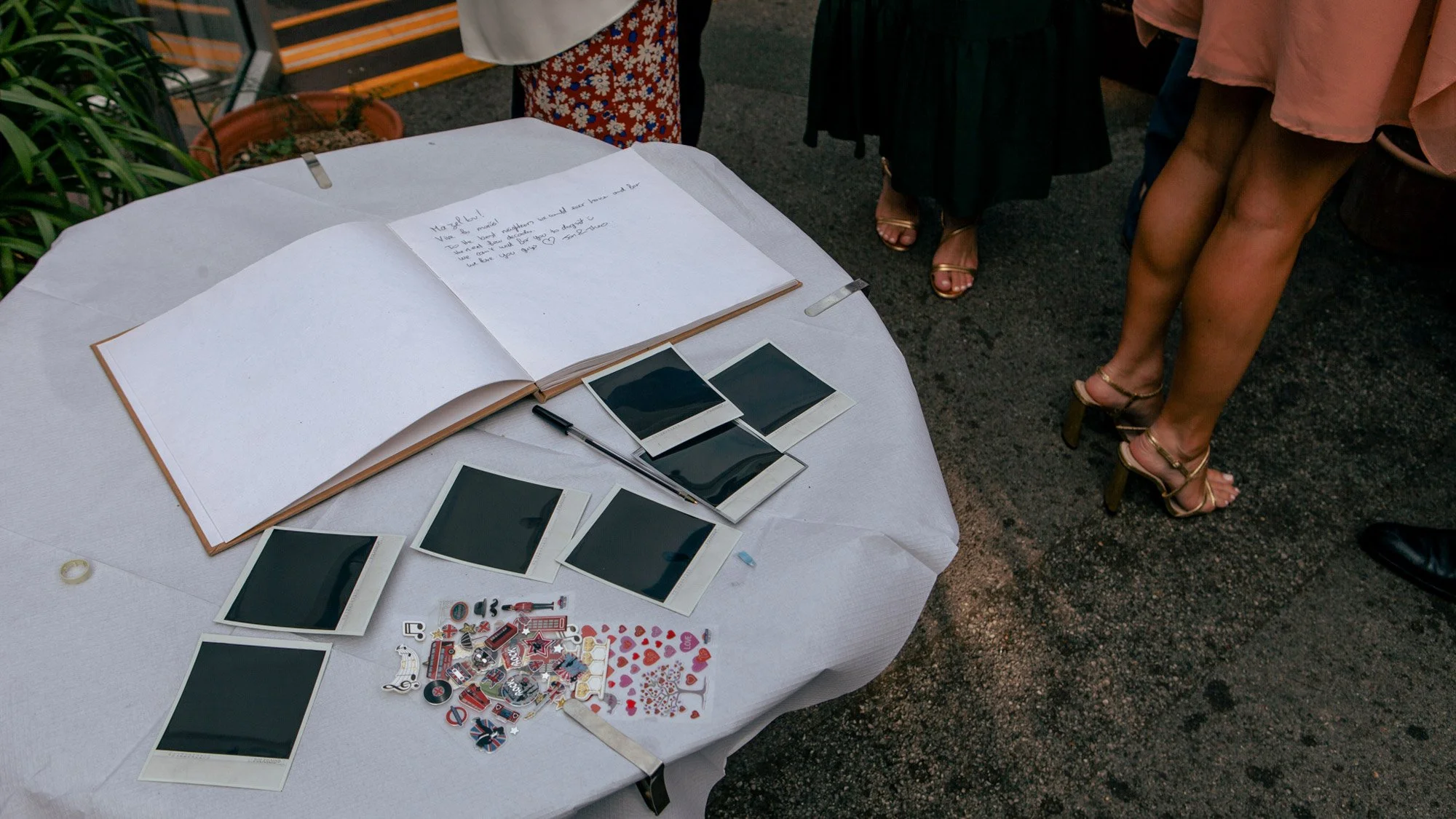 polaroids and guest book on table at wedding.jpg