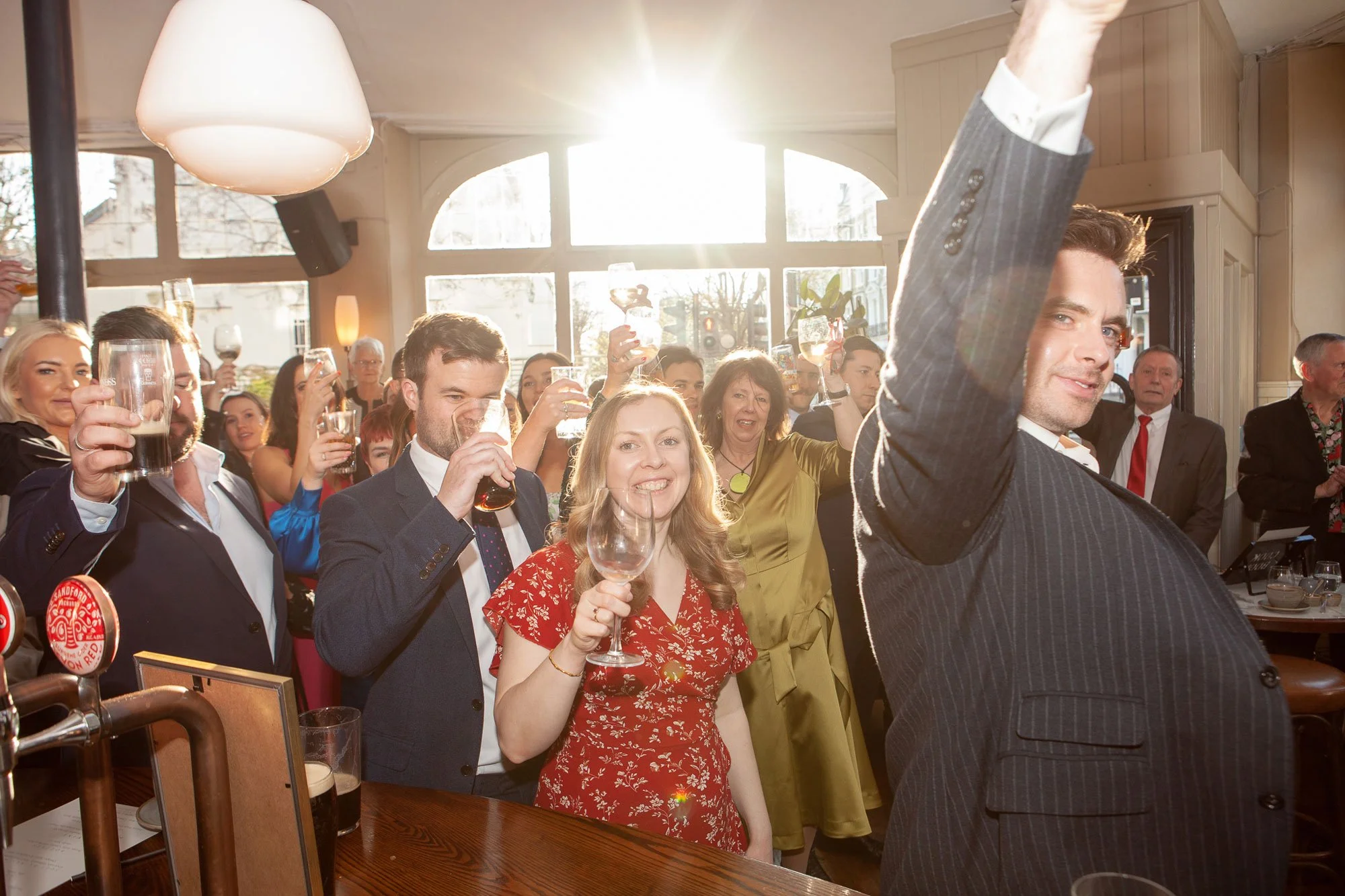 Guests-at-wedding-celebrating-in-pub-with-drinks.jpg
