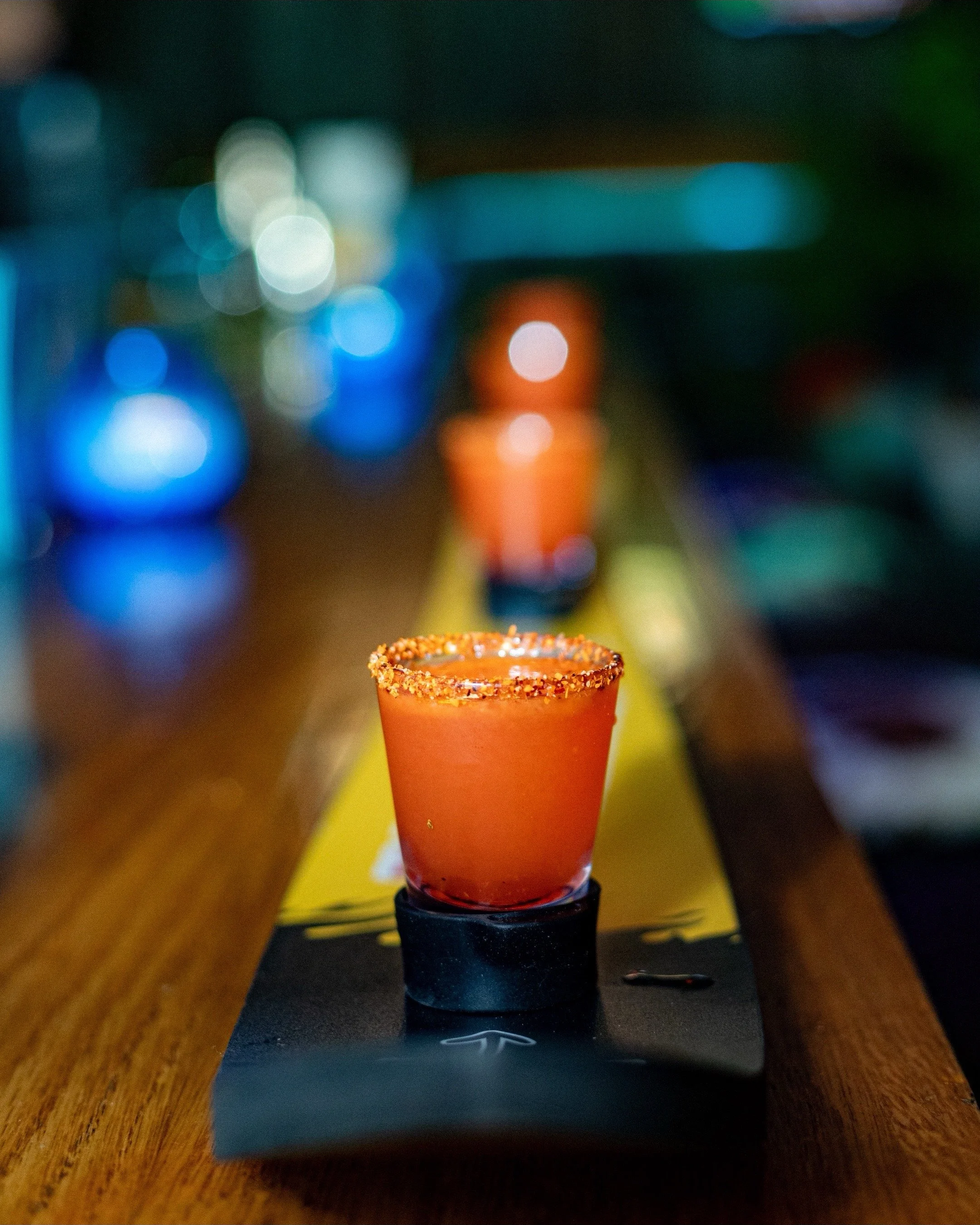 A shotski laid across the bar with Mexican Candy shots. 