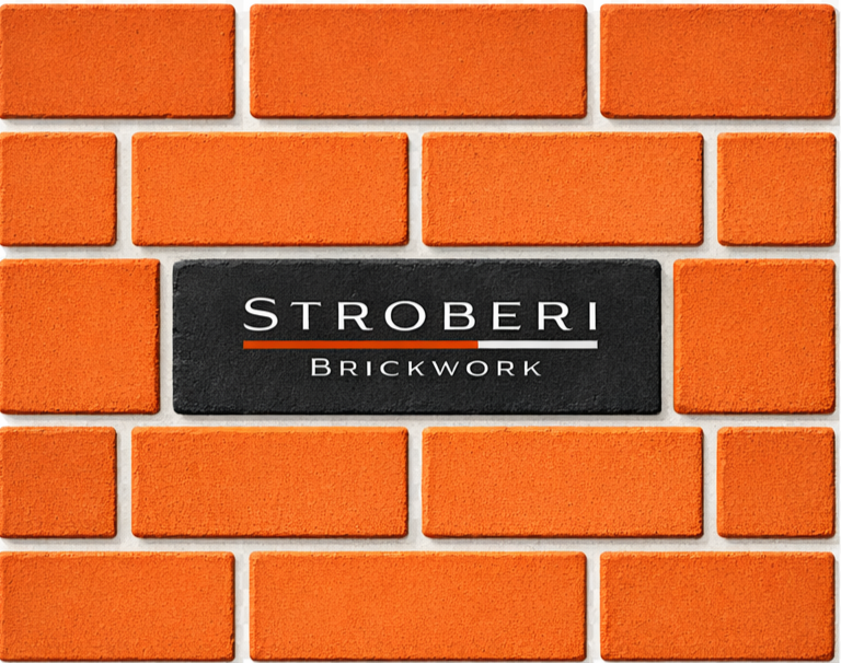 Close-up of a brick wall with a black sign reading "Stroberi Brickwork".