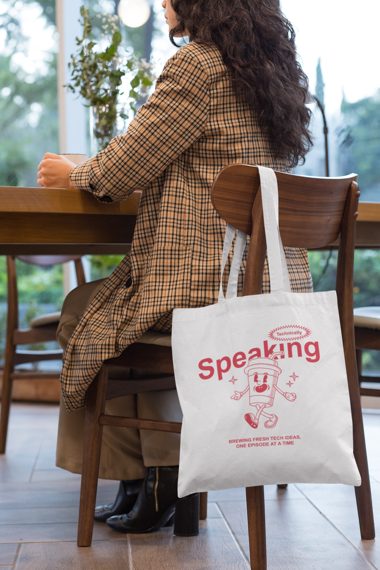 tote-bag-mockup-of-a-woman-sitting-on-a-chair-29457.png