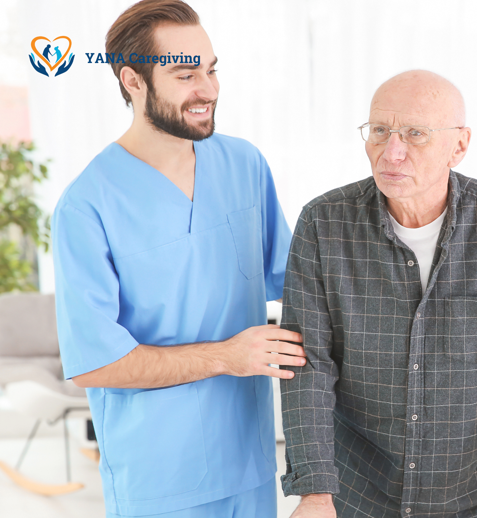 A caregiver in light blue scrubs comforting an elderly man with glasses and a checkered shirt in a healthcare setting.