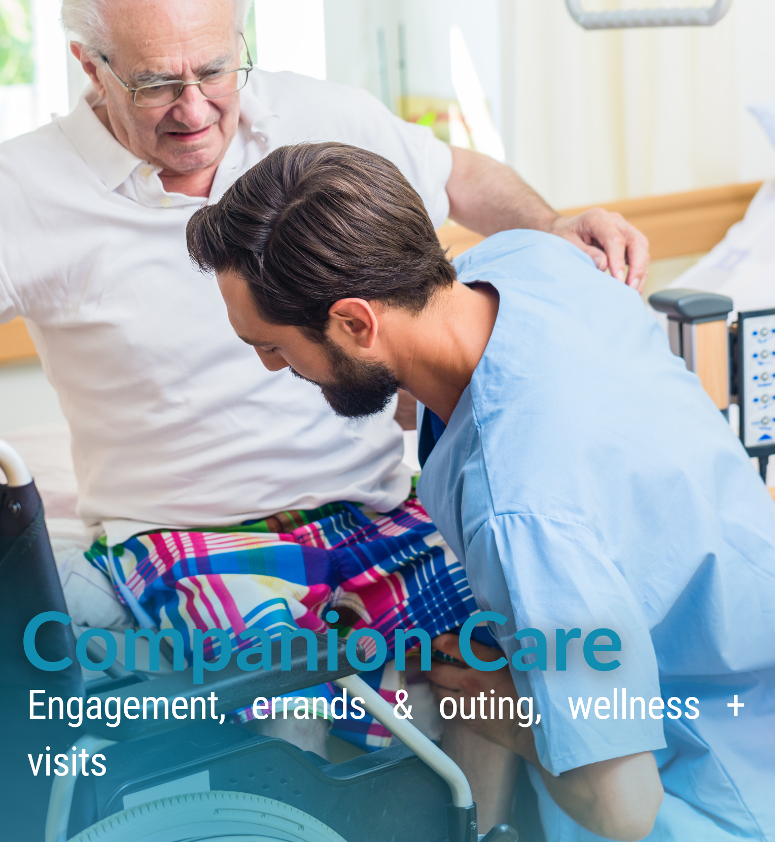 A young male healthcare worker in blue scrubs leaning over an elderly man in a hospital bed, who is wearing a white shirt and colorful plaid shorts. An older male caregiver with glasses is standing nearby, observing. The scene takes place in a bright, clinical setting, possibly a hospital or care facility, with medical equipment visible in the background.