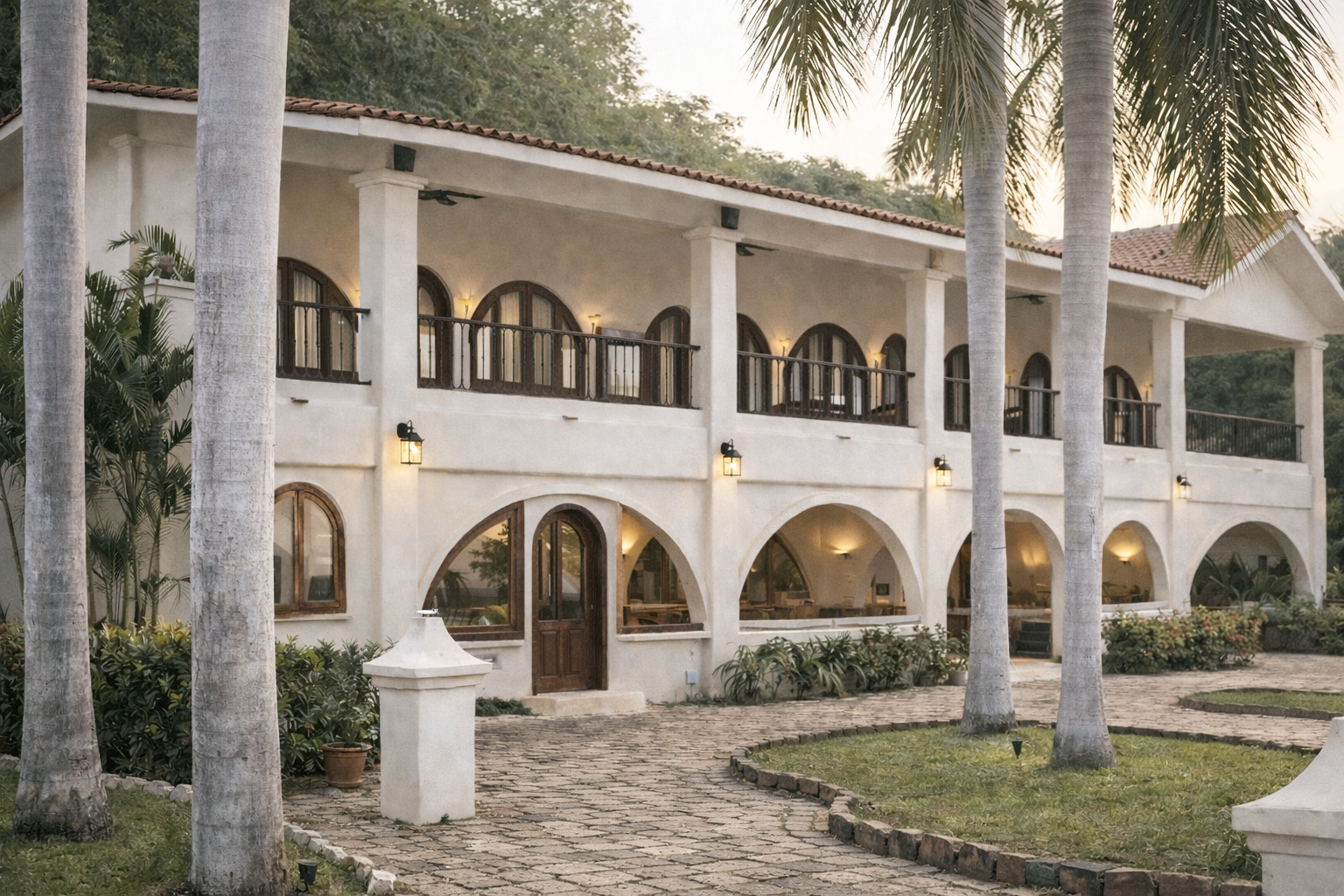 The main hacienda at ZAIA blends Spanish-inspired architecture with tropical landscaping, arched corridors, and warm evening light—offering an elegant yet relaxed setting along Mexico’s Pacific coast.