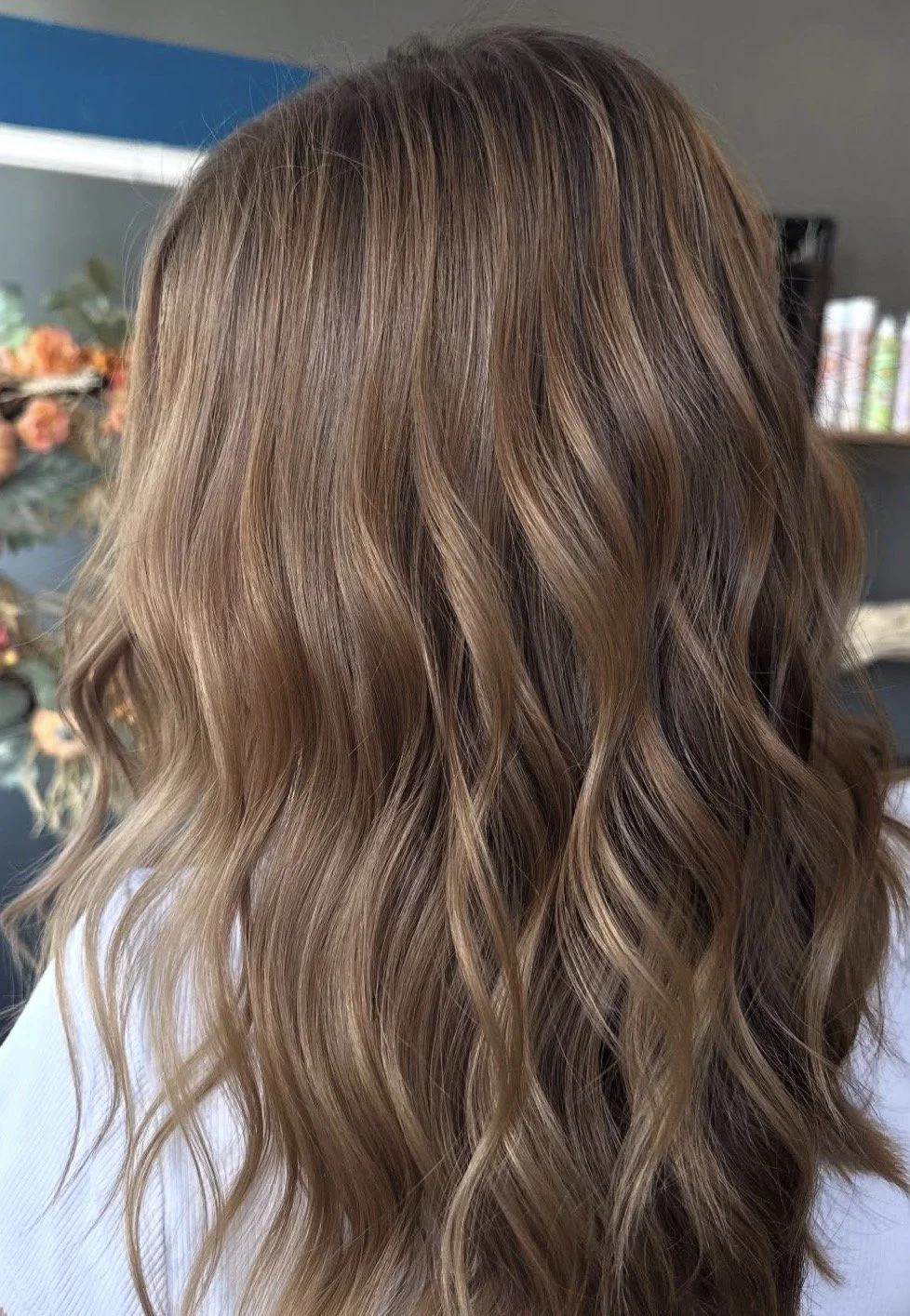 Close-up of wavy, light brown hair with subtle blonde highlights.