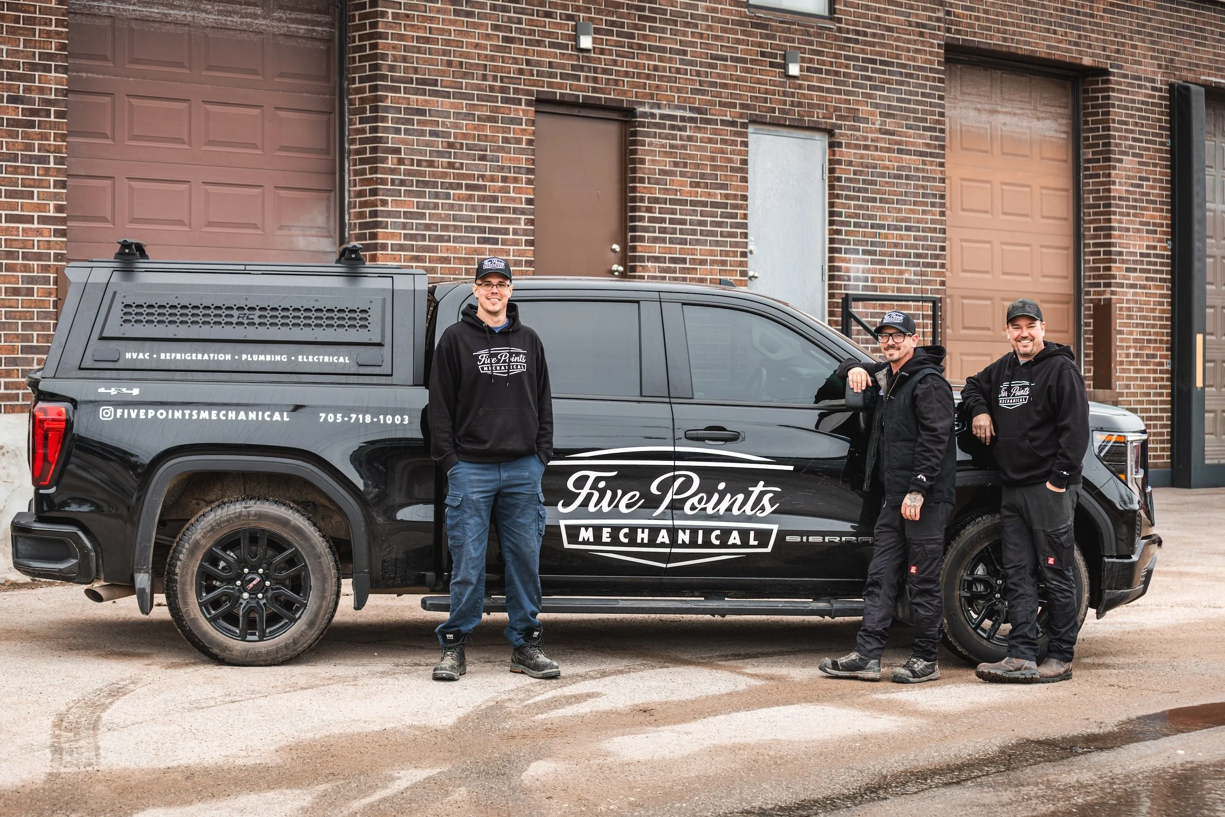 Five Points Mechanical HVAC team standing beside branded service truck in Barrie Ontario