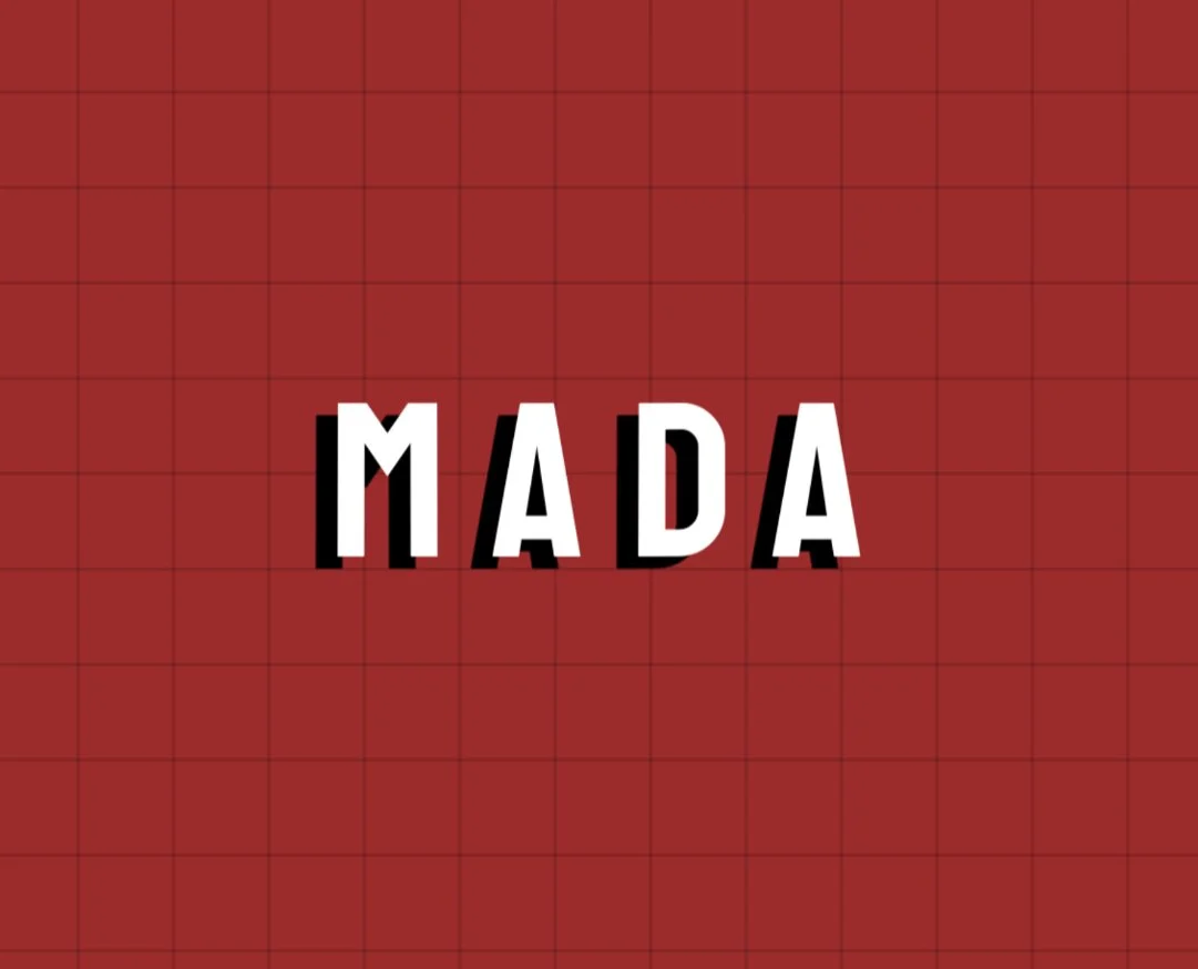 The "MADA"  Logo in uppercase white letters with black shadows on a red grid background.