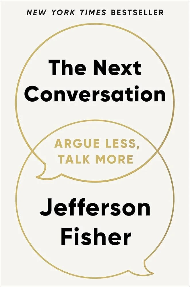 Book cover titled 'The Next Conversation' by Jefferson Fisher, with the subtitle 'Argue Less, Talk More', labeled as a New York Times Bestseller.