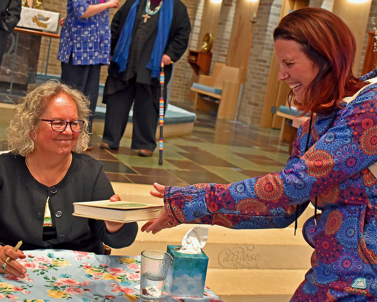 A Very Happy Fan Receiving Signed Book, credit.png