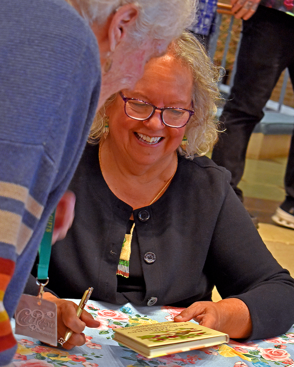 Robin Wall Kimmerer, Smiling after Signing Book, credited.png