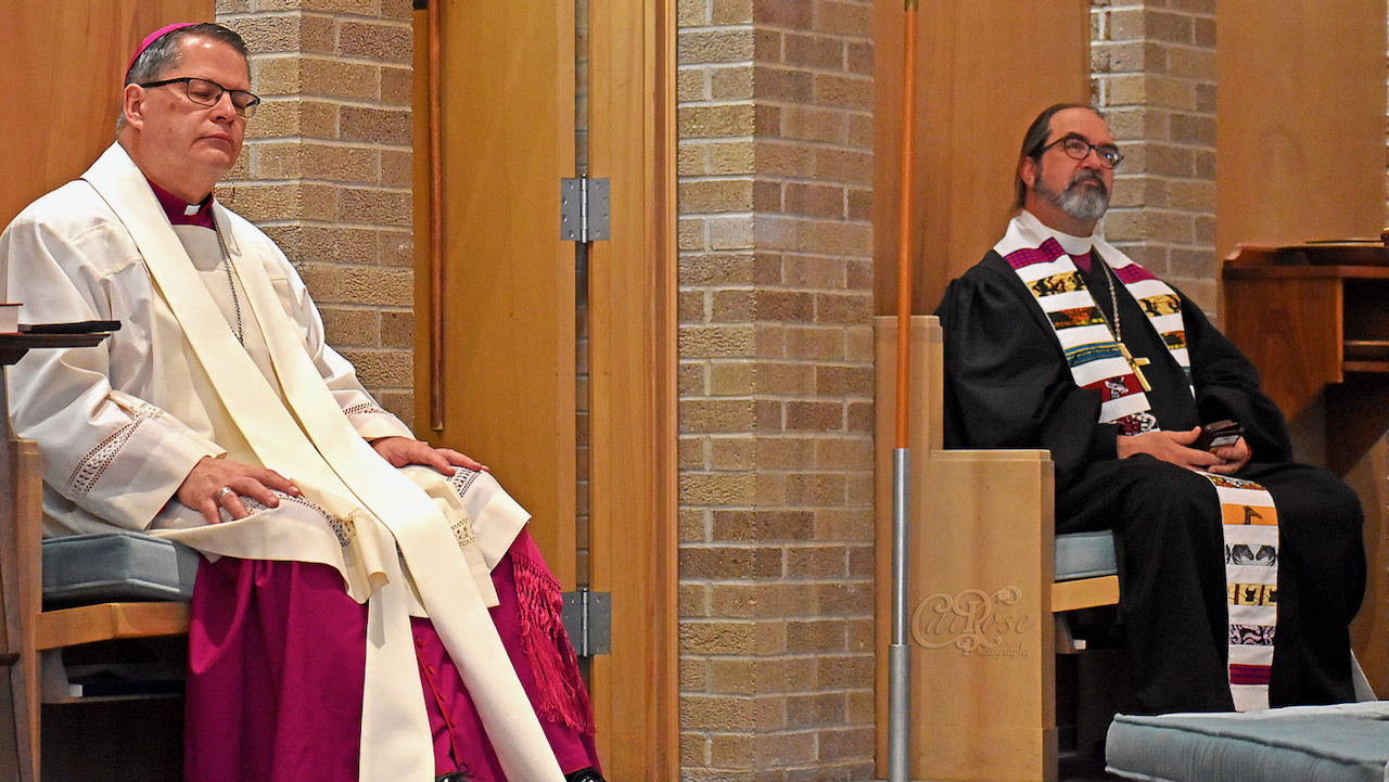 Bishop with Cap and Tall Bishop Listening to Bishop Carol_s Sermon, credited.png