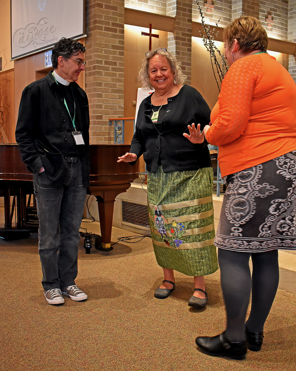 Robin Wall Kimmerer Chating with Canon David Stickley and CoChair in Orange Shirt, credited.png