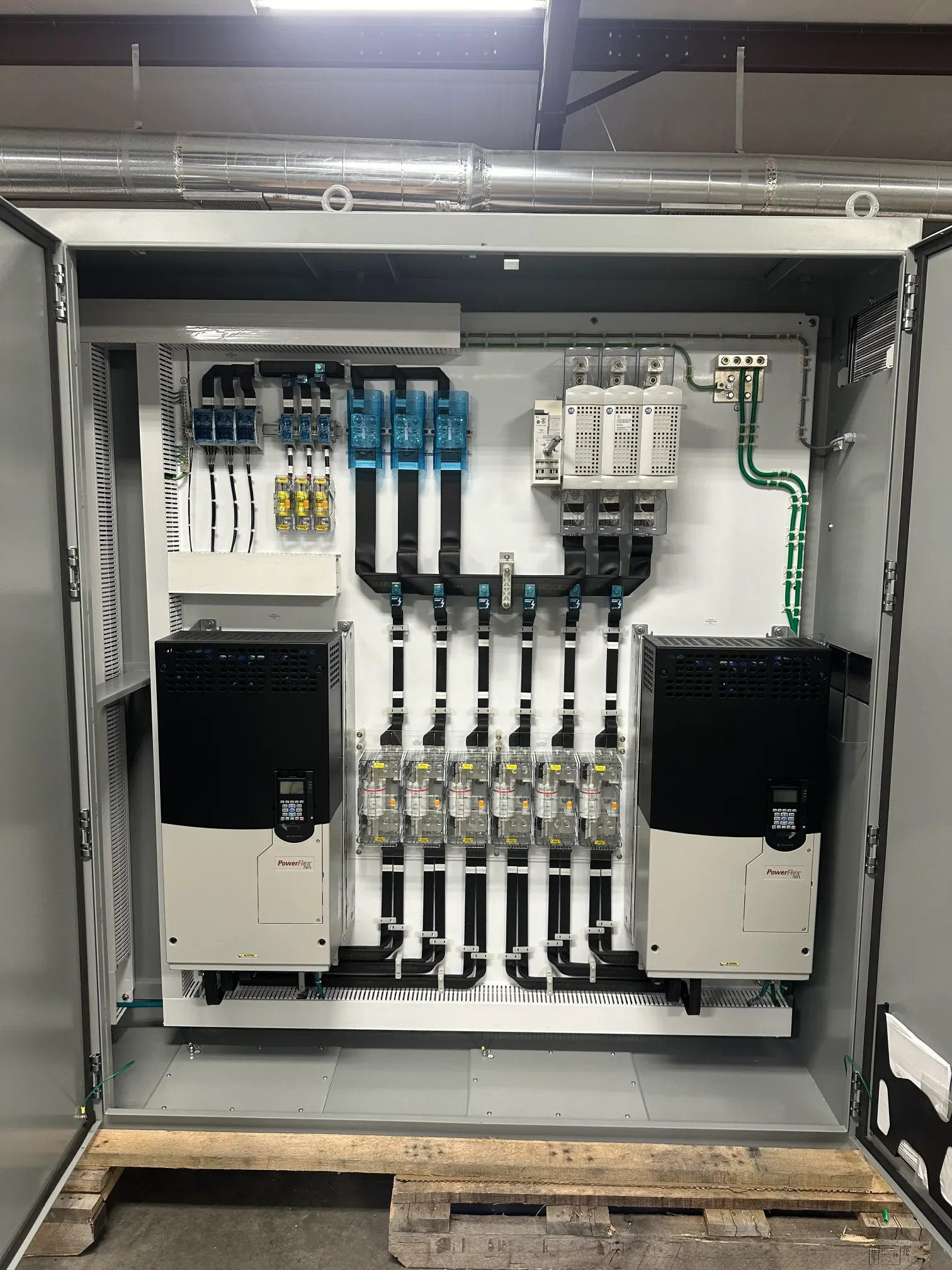 An industrial electrical control panel with various components, wiring, and circuit breakers.