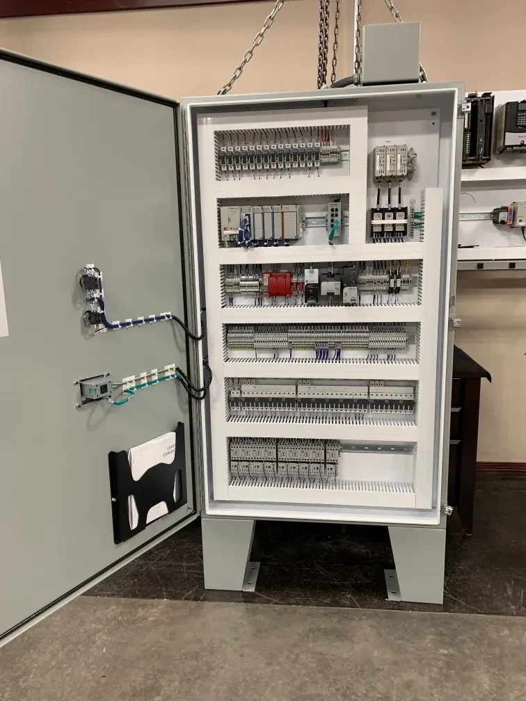 Electrical control panel with wired components and circuit modules inside.