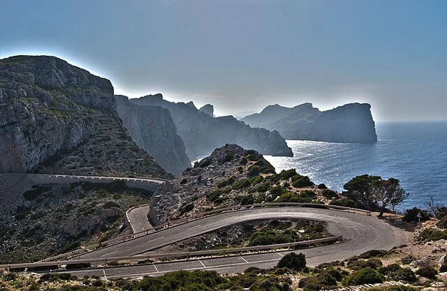 Winding coastal road along cliffs with ocean in the background