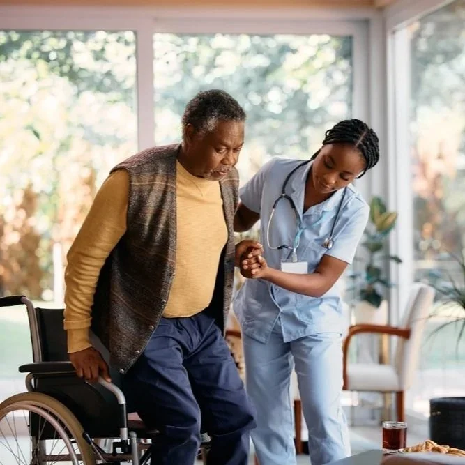 19635-African+American+senior+man+getsup+from+wheelchair+with+help+of+nurse+in+nursing+home+shutterstock_2281228945.jpg