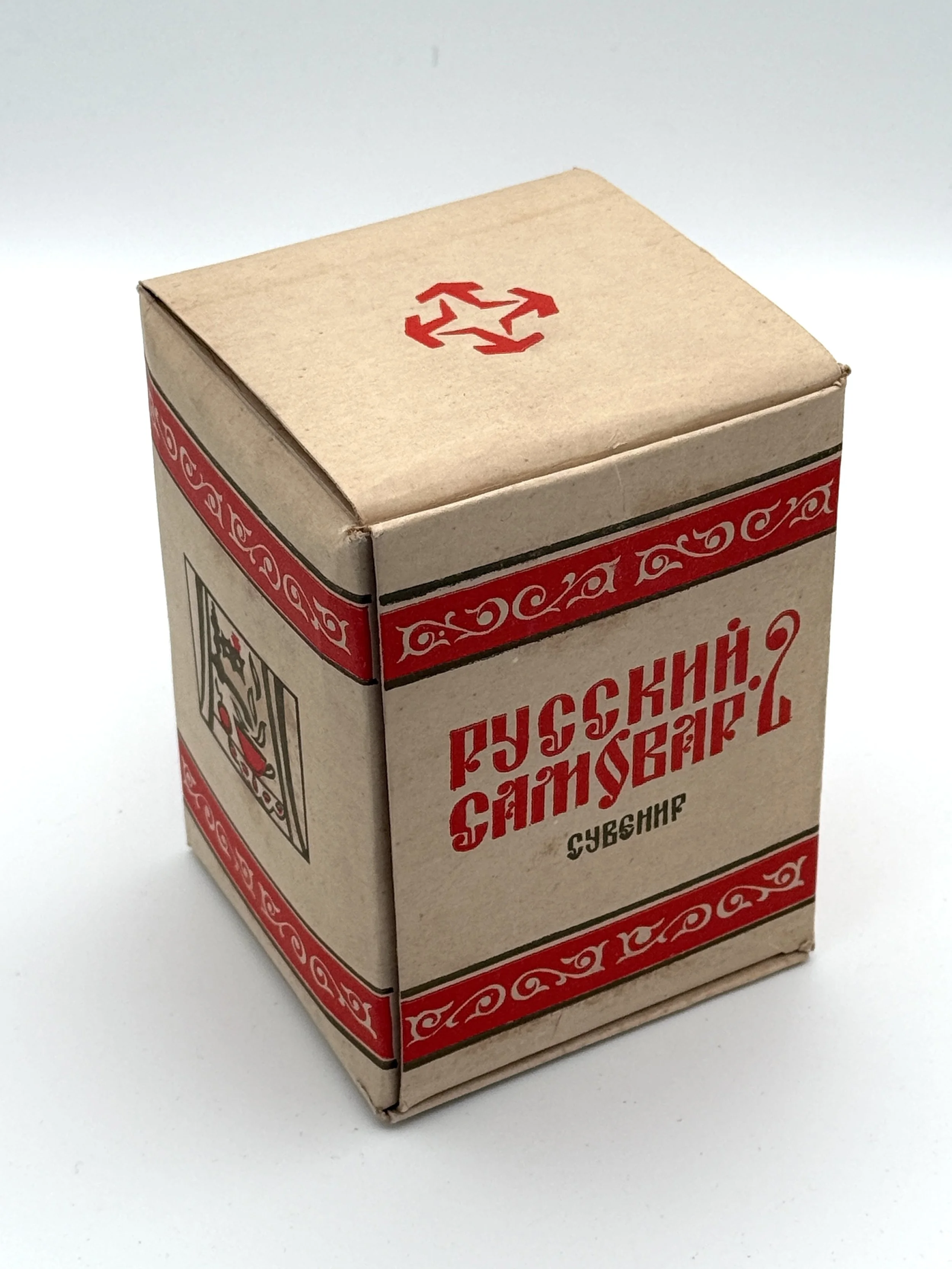 A small cardboard box with red and black design elements, featuring the word "SUBSH