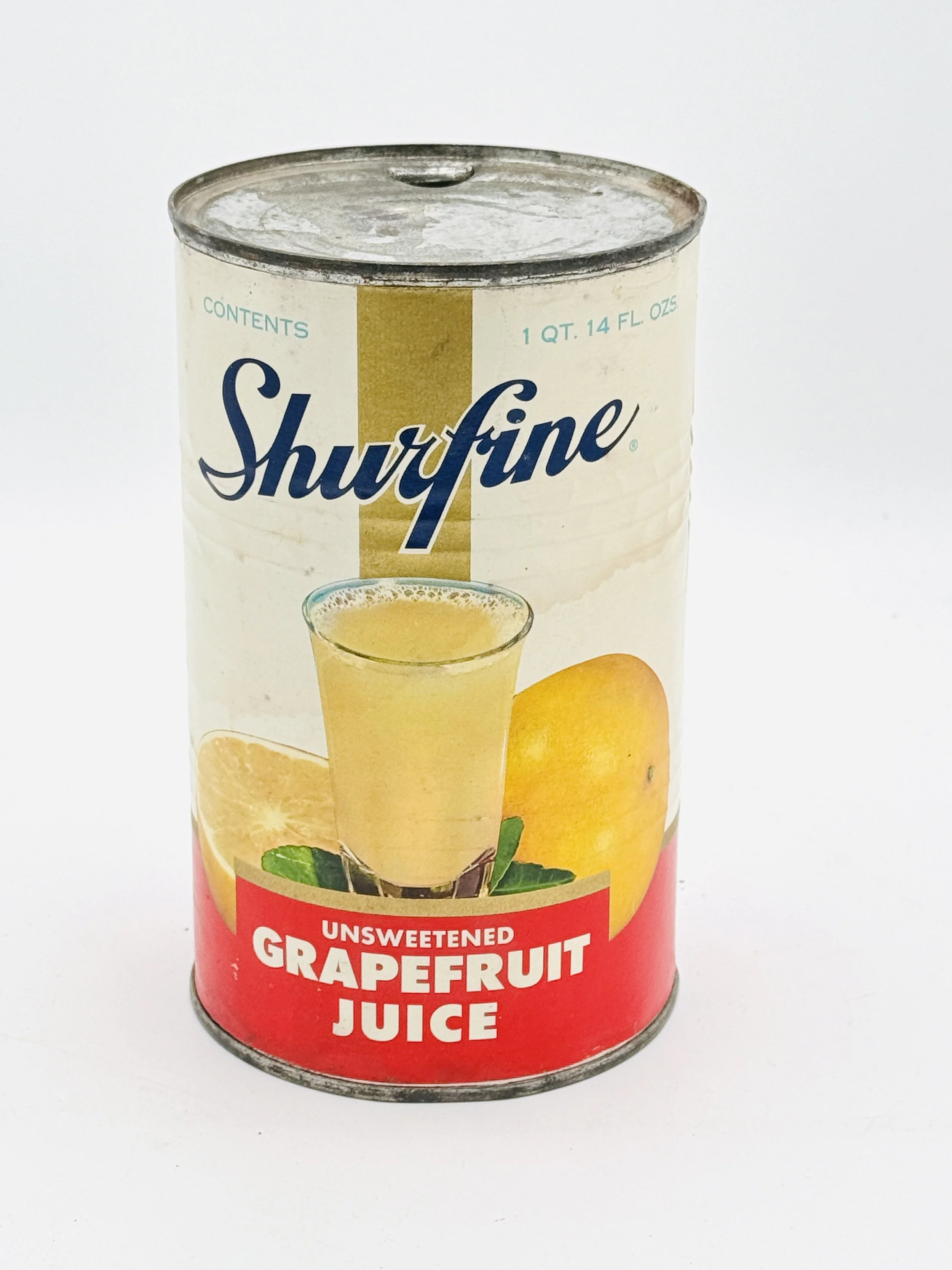 A can of Shurfine unsweetened grapefruit juice with a picture of a glass of juice and oranges on the label.