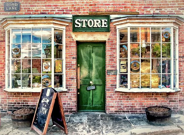 Brick storefront with green door, large windows displaying pottery and decorations, and a sign reading 'STORE' above the door. A chalkboard sign outside, and two large planters on either side. Street sign 'Load Lane' in the top left corner.