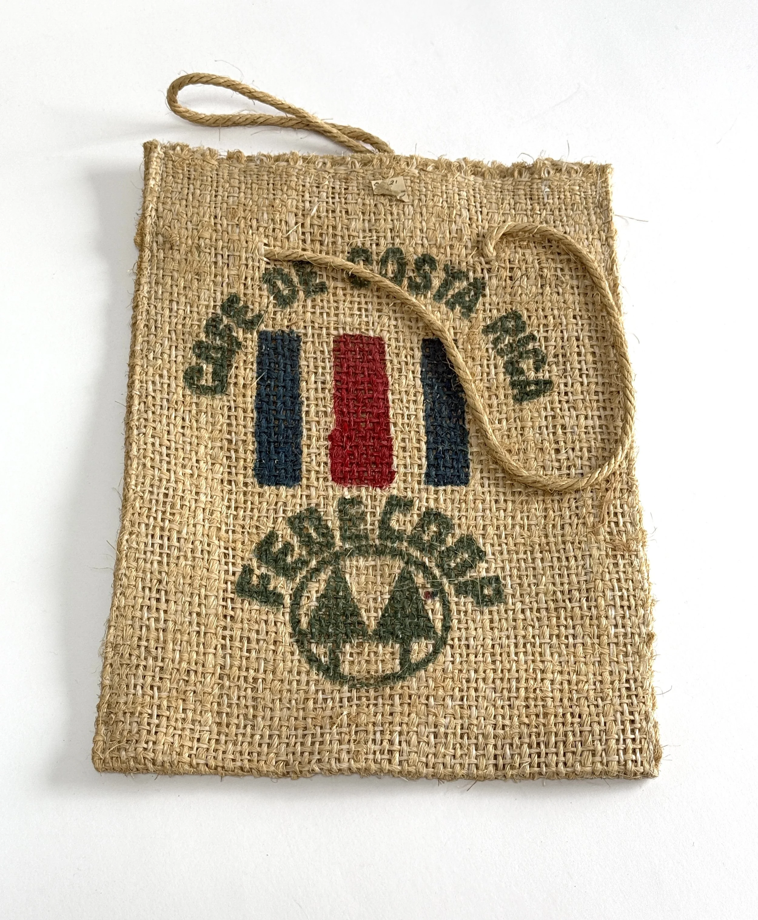 A woven fabric with the Coca-Cola logo, consisting of red, white, and blue stripes, and the words "Drink Coca-Cola" written above and below the logo.