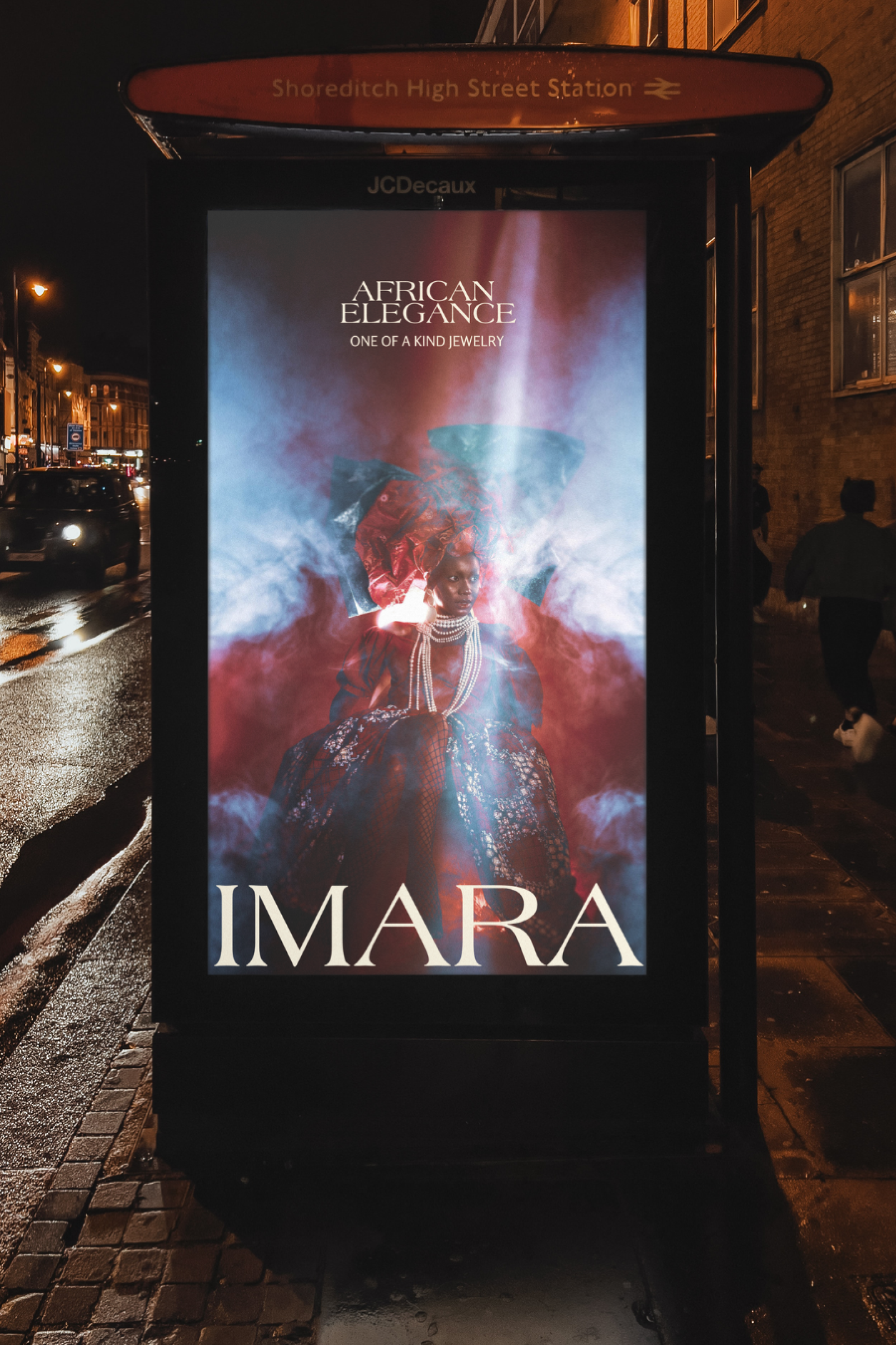 Nighttime advertisement for a jewelry brand called African Elegance featuring a woman in traditional African attire with jewelry, surrounded by colorful smoke effects, on a bus stop poster in Shoreditch.