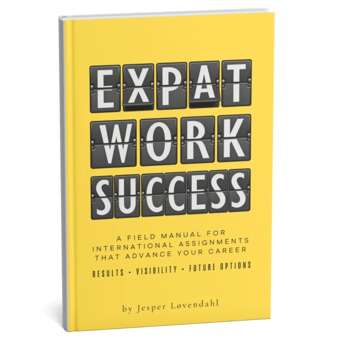 Yellow book titled "Expat Work Success," with black and white flip-style letters spelling out the words, and subtitle about a manual for international assignments by Jesper Løvendahl.