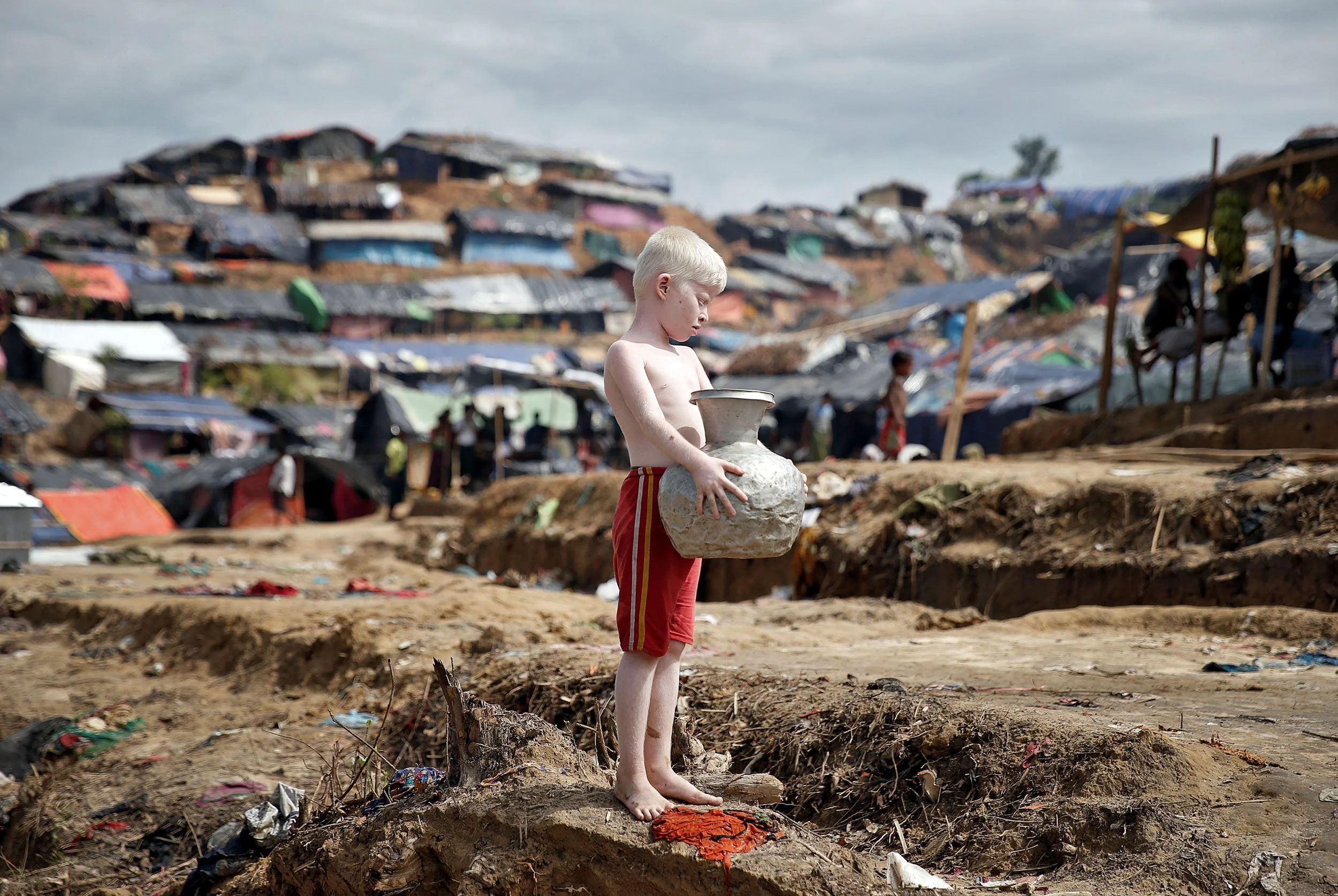 Boy with water jug, Bangladesh.