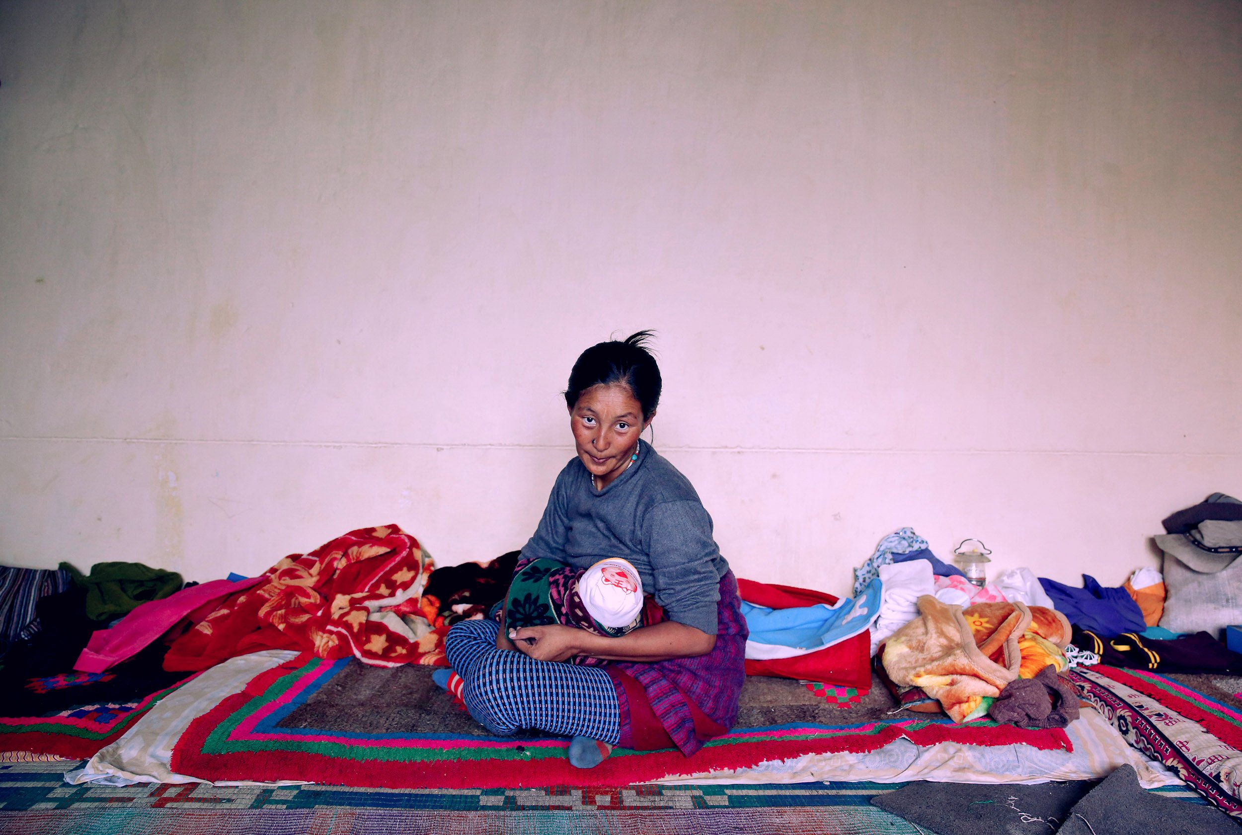 Mother feeds baby, Leh.