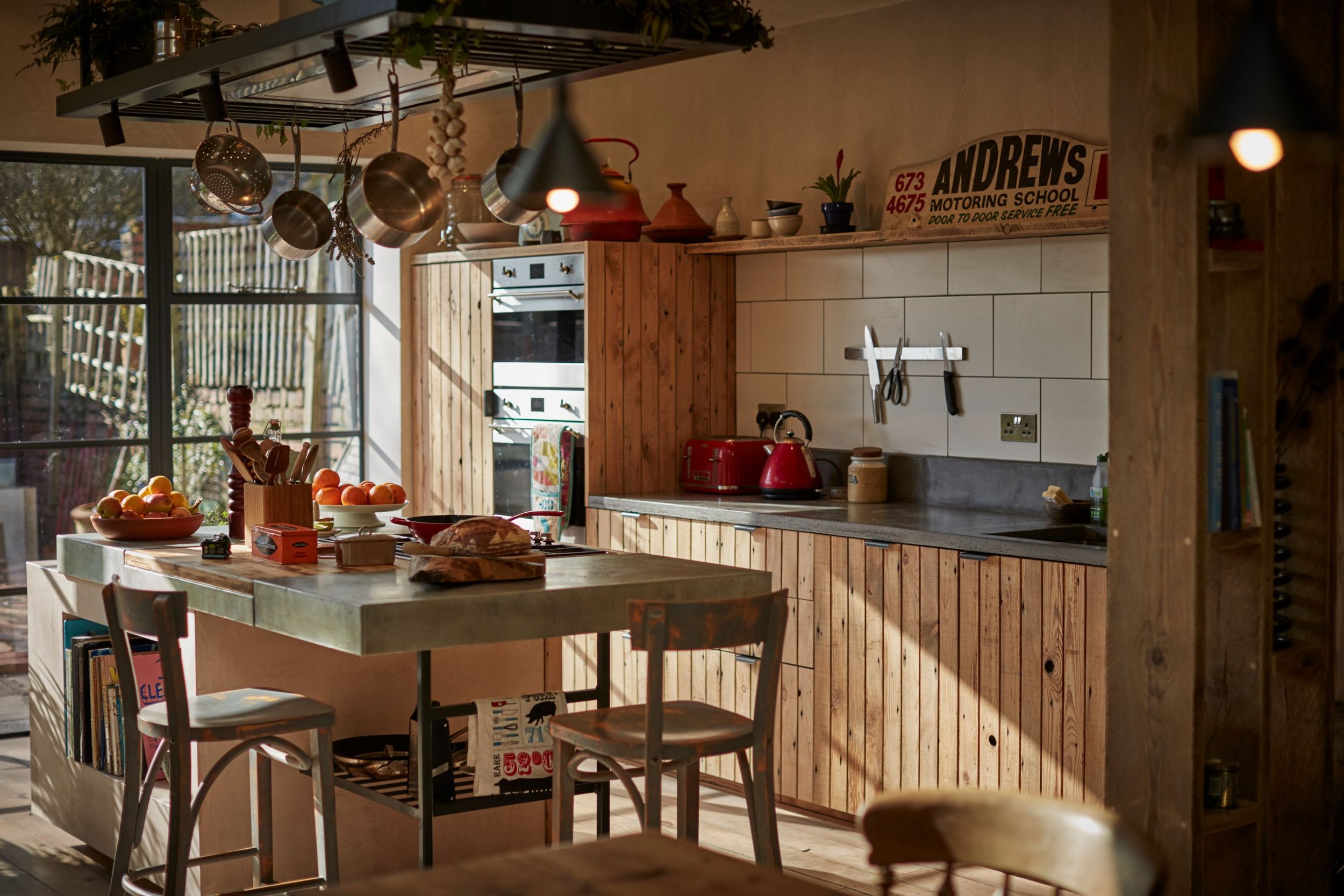 Reclaimed wooden kitchen with concrete worktop. Eclectic kitchen island