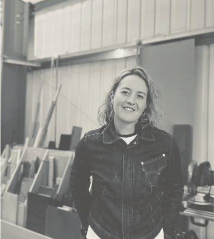 Image of a female wood worker standing in her workshop