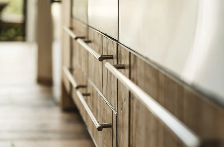 close up of a kitchen with a mix of reclaimed timber and stainless steel