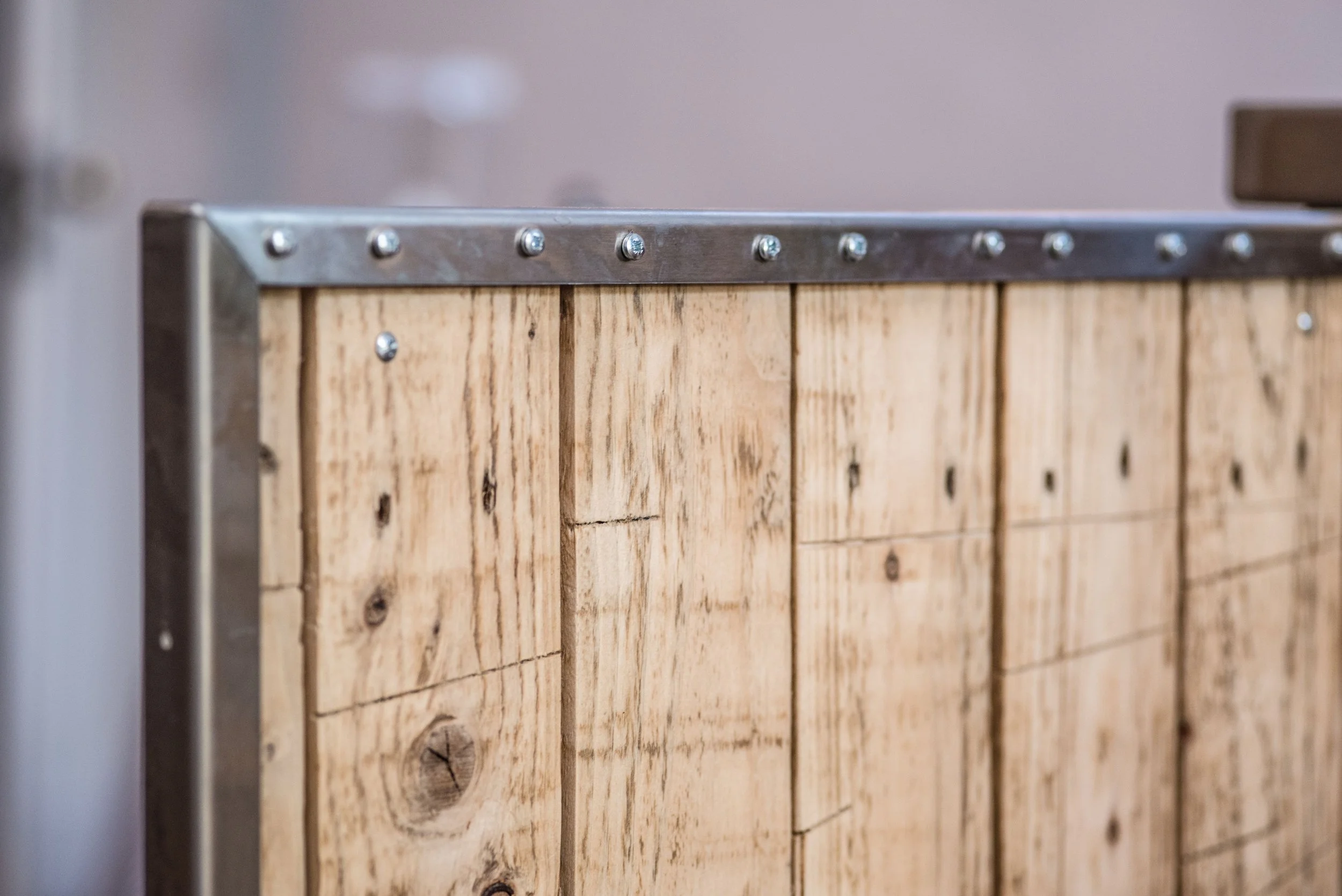 Kitchen doors made from reclaimed pallets encased in industrial frames.
