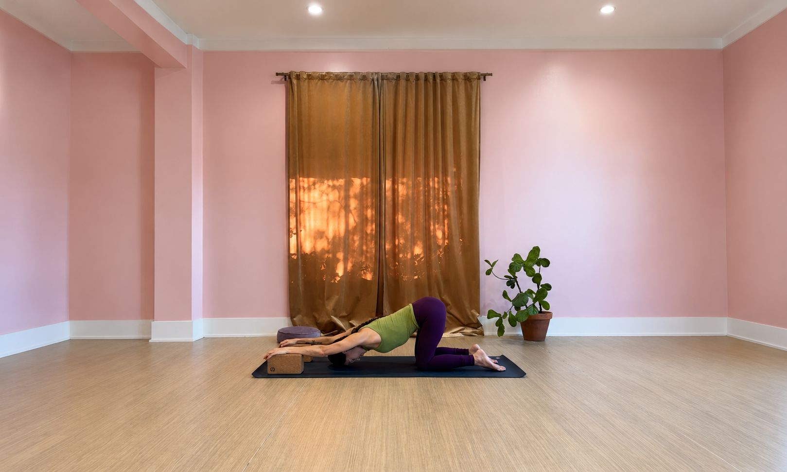 Erinn Arizcorreta demonstrates a restorative seated fold using two blocks. A variation of puppy or heart melting pose for an online stress relief class. She is at Sukha Yoga Tarrytown studio near Lake Austin Blvd and 35th street in central Austin.