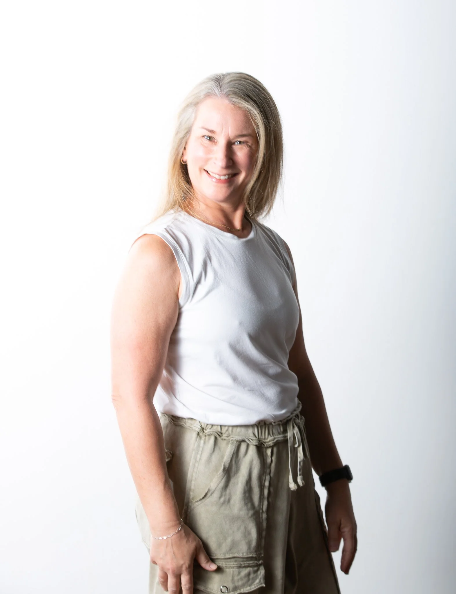 Sukha Yoga Austin Heated and Non Heated Power Yoga Teacher Lauren Lent smiling in image.