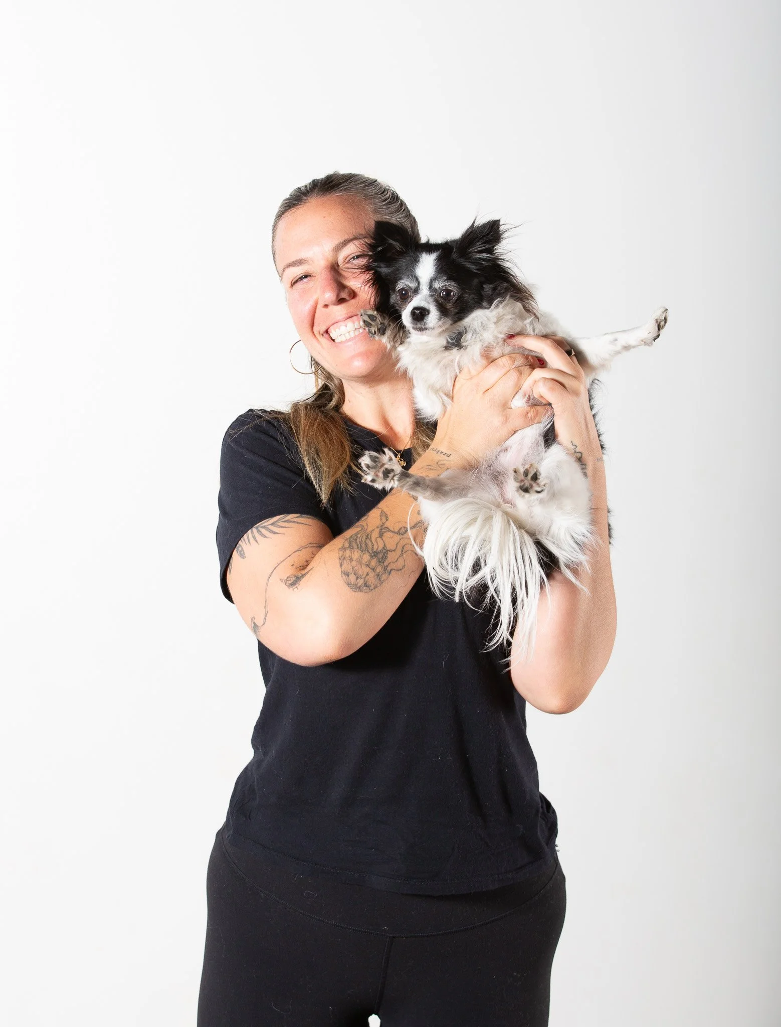 Sukha Yoga Austin Teacher, Kirby Gordon and Gracie the yoga dog smiling at the camera.