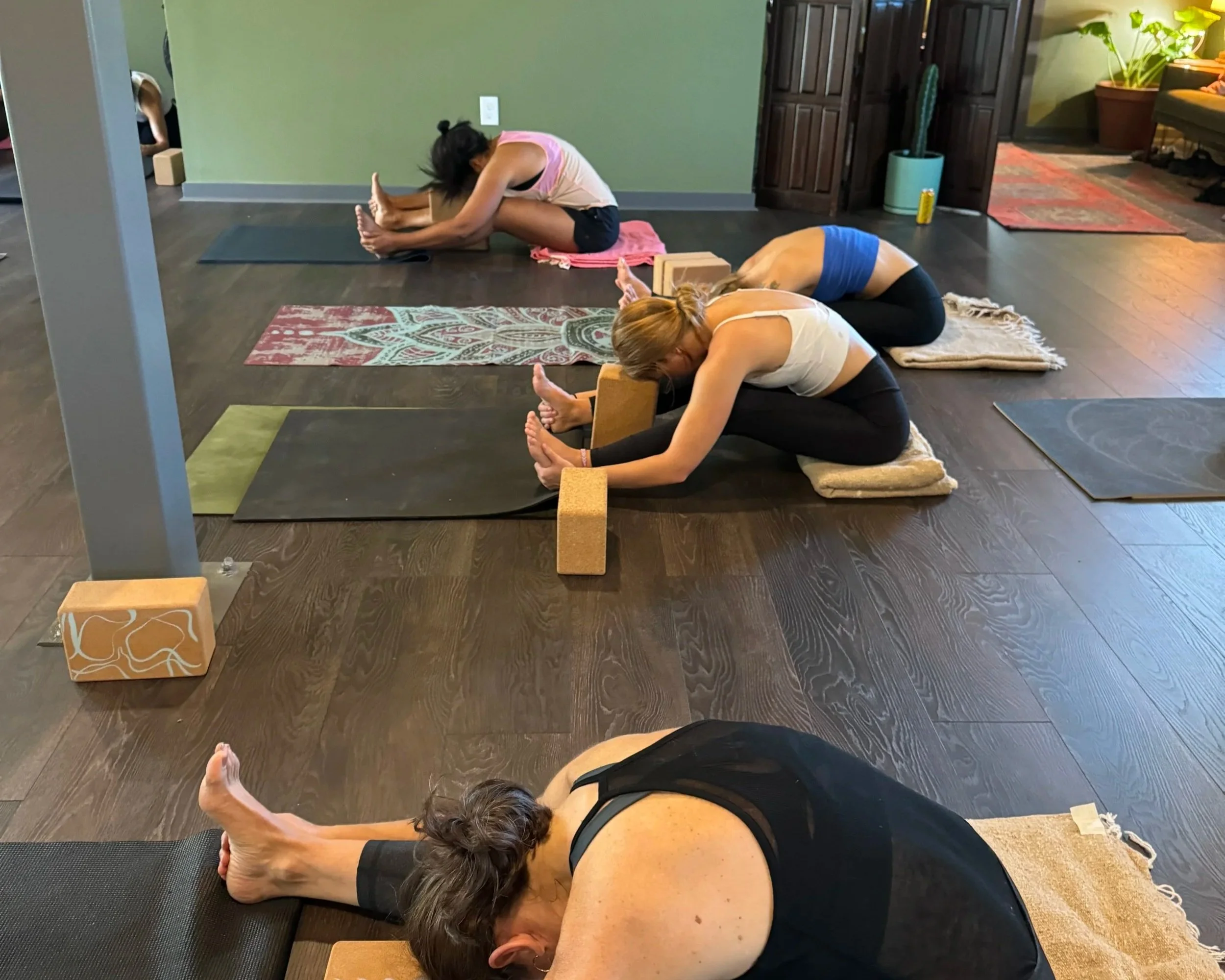 Yin Yoga Students in a Supported Seated Fold at Sukha Yoga Austin