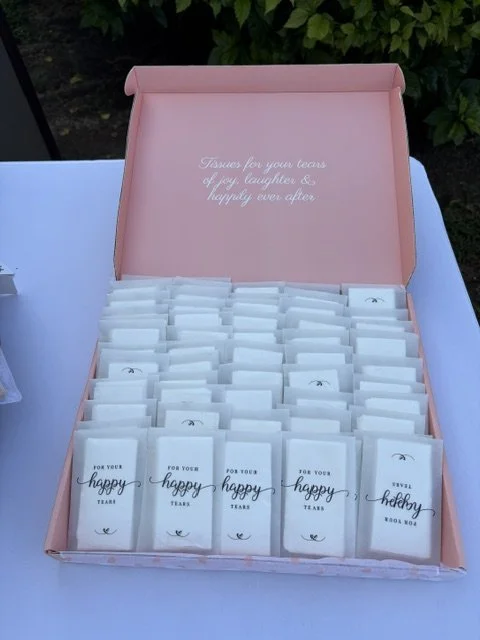 A pink box with tissues inside, labeled as tissues for tears of happiness or sorrow.