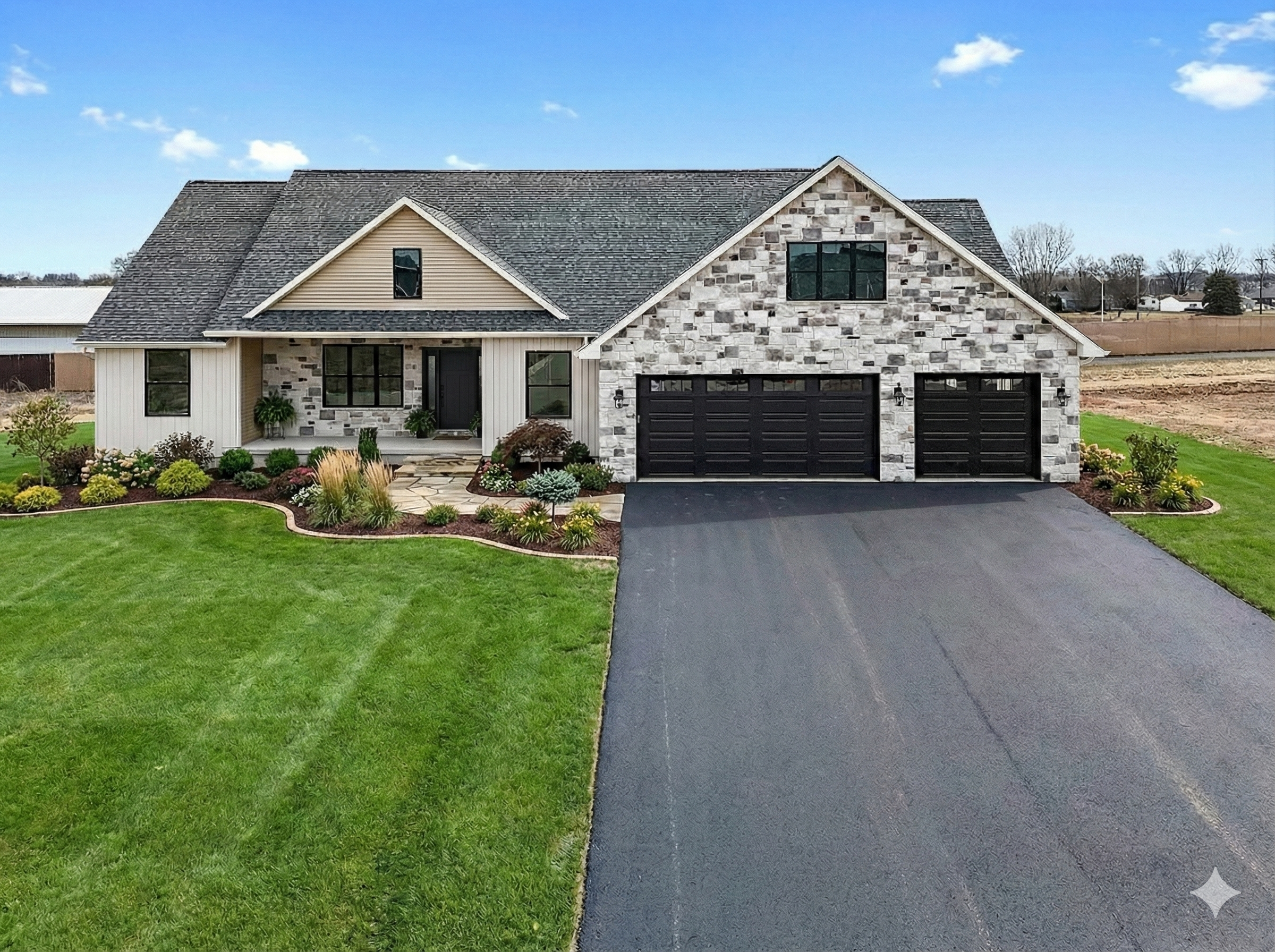 A modern two-story house with a landscaped front yard, stone and siding exterior, black garage doors, and a paved driveway.