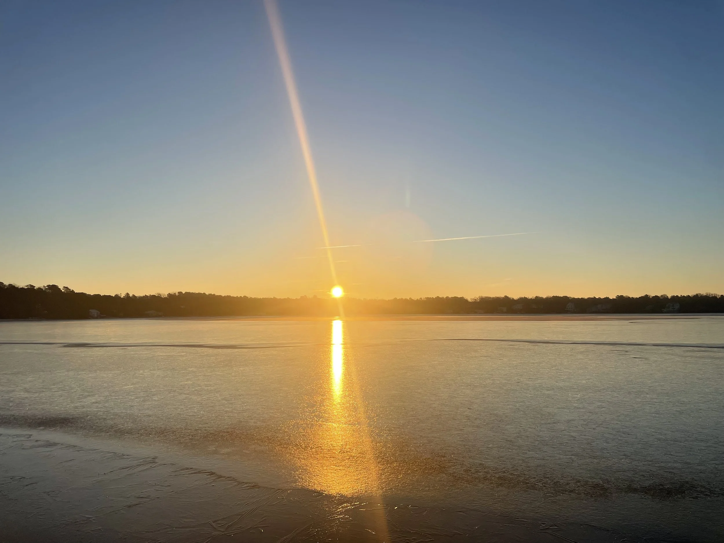 Sunrise over frozen lake