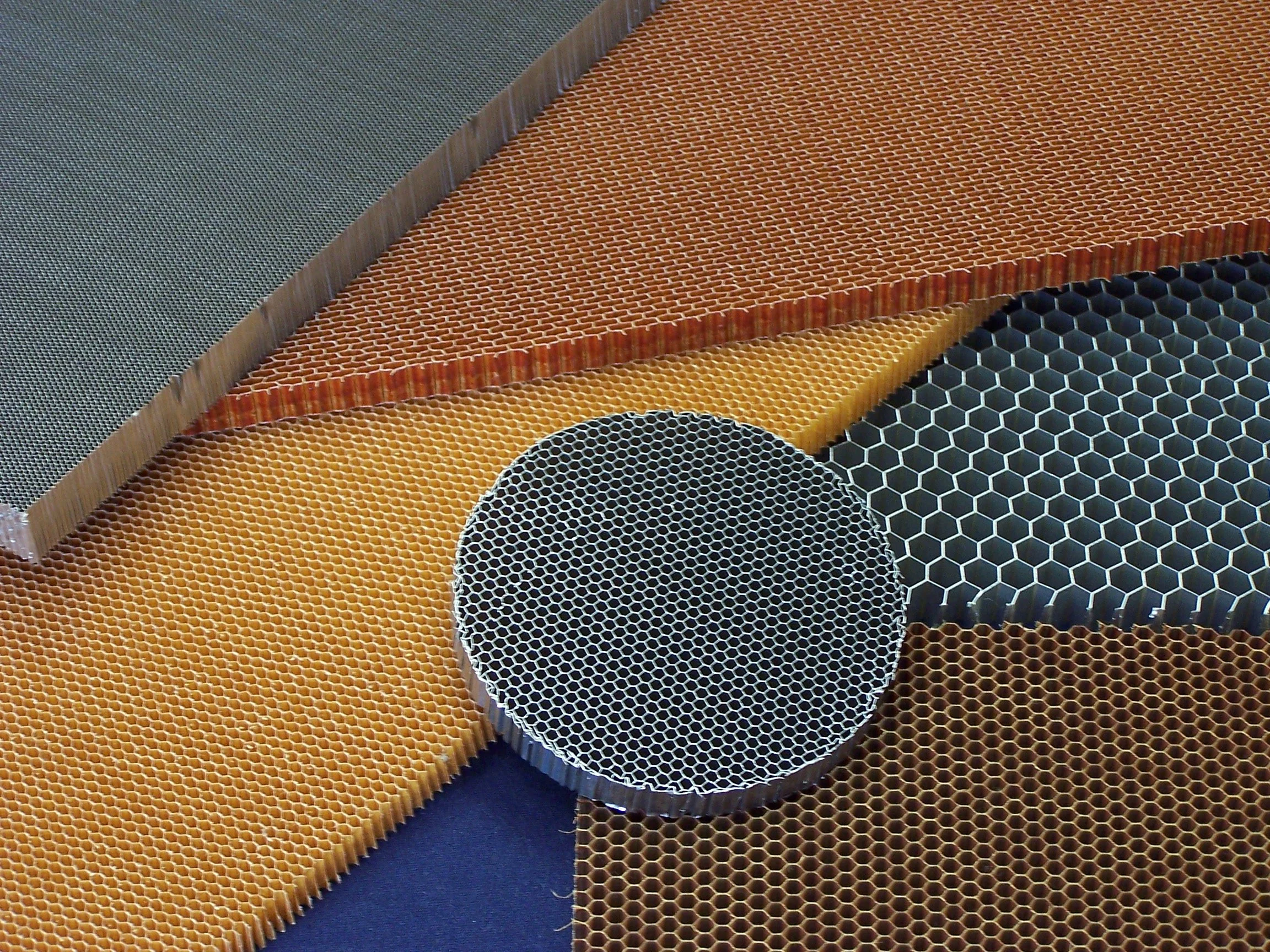 Close-up view of various honeycomb structures with different colors and hexagonal patterns.