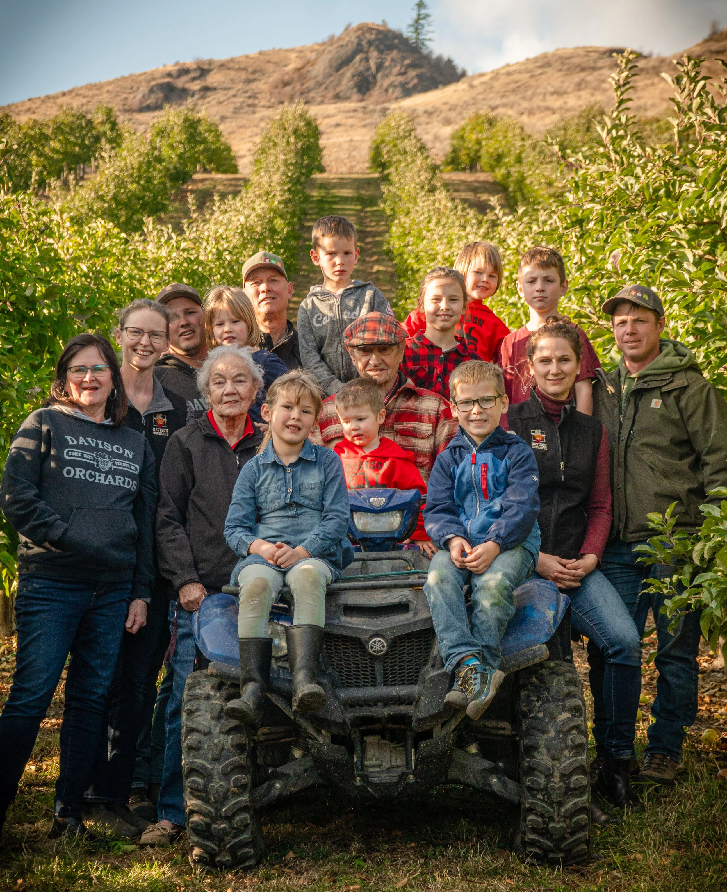 Davison family five generations standing together in the apple orchard at Davison Orchards in Vernon BC, Okanagan Valley Canada