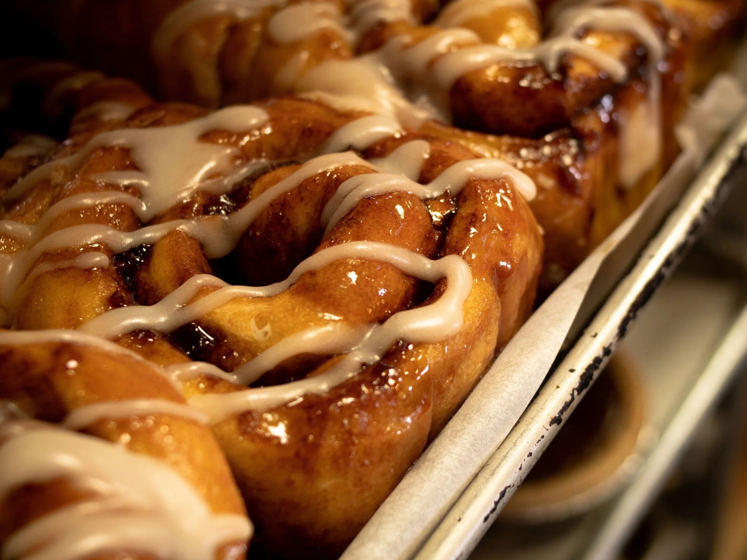 Fresh apple cinnamon rolls on a baking tray made at the Farmhouse Bakery at Davison Orchards in Vernon BC, Okanagan Valley