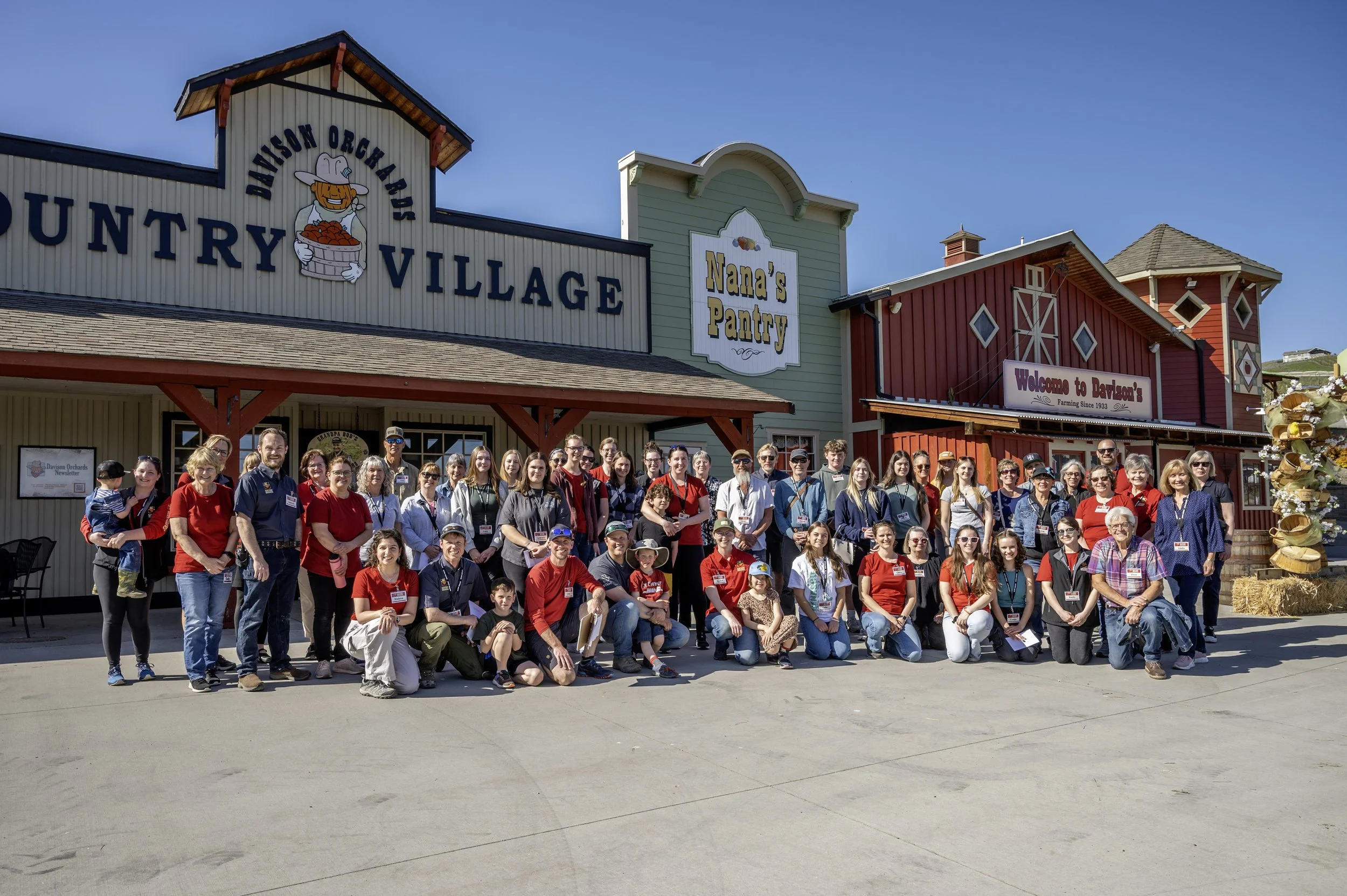 Davison Orchards 2025 team sitting in front of the Country Village during Orientation Day 2025 in Vernon BC, Okanagan Valley Canada