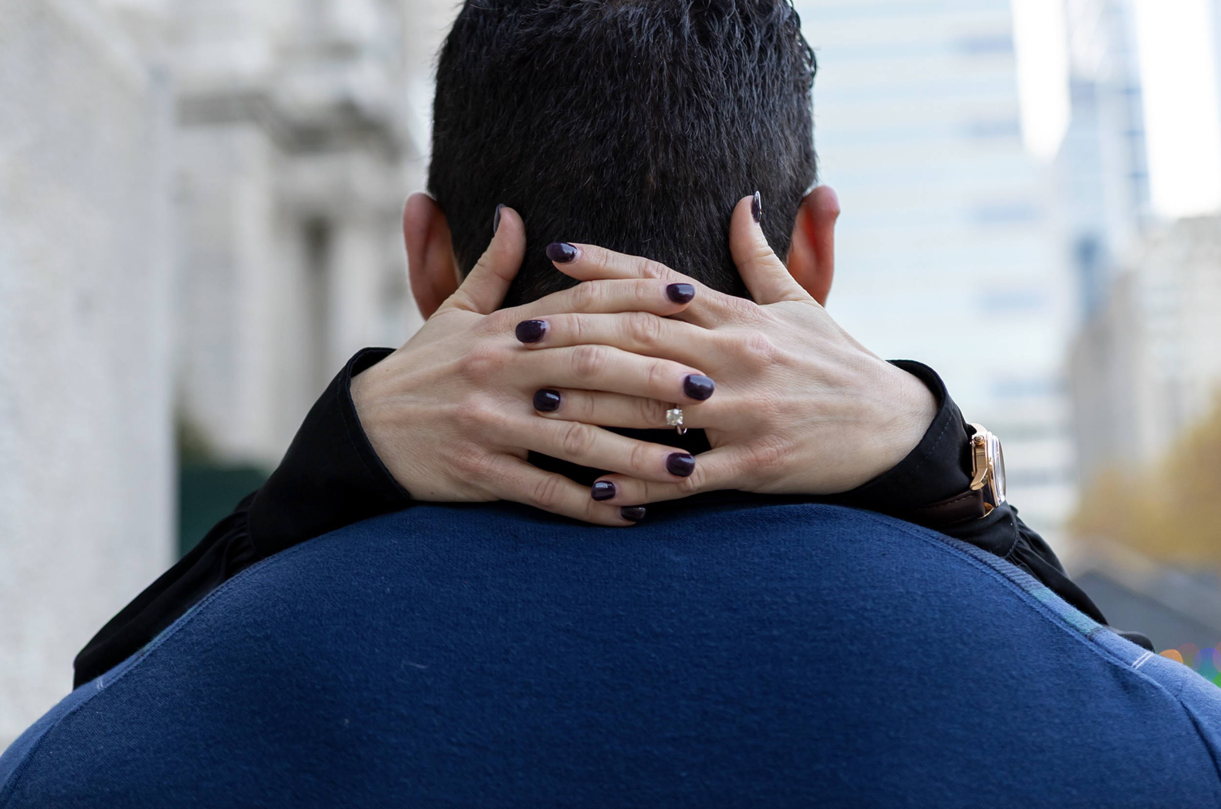 Philadelphia City Hall Engagement Photos, Focusing on the ring behind the man, after proposal in Love Park, Philadelphia, PA.