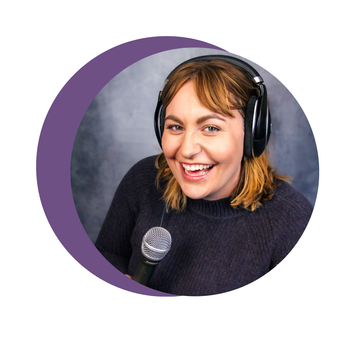 Jess is smiling at the camera with a microphone in her hand and headphones on