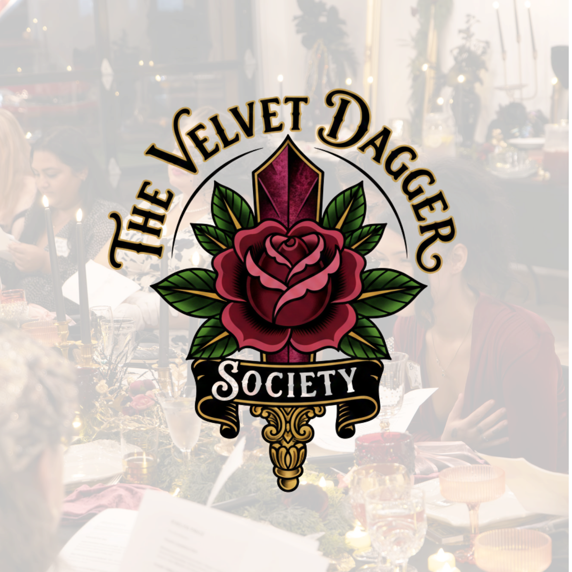 A festive dinner party with women seated around a table decorated with candles, flowers, and glasses. A large, elaborate logo overlay reading 'Velvet Dagger Society' with a stylized rose and leaves is in the center.